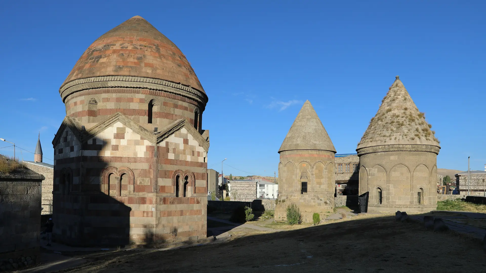 The Three Mausoleums of Erzurum beneath a clear blue sky