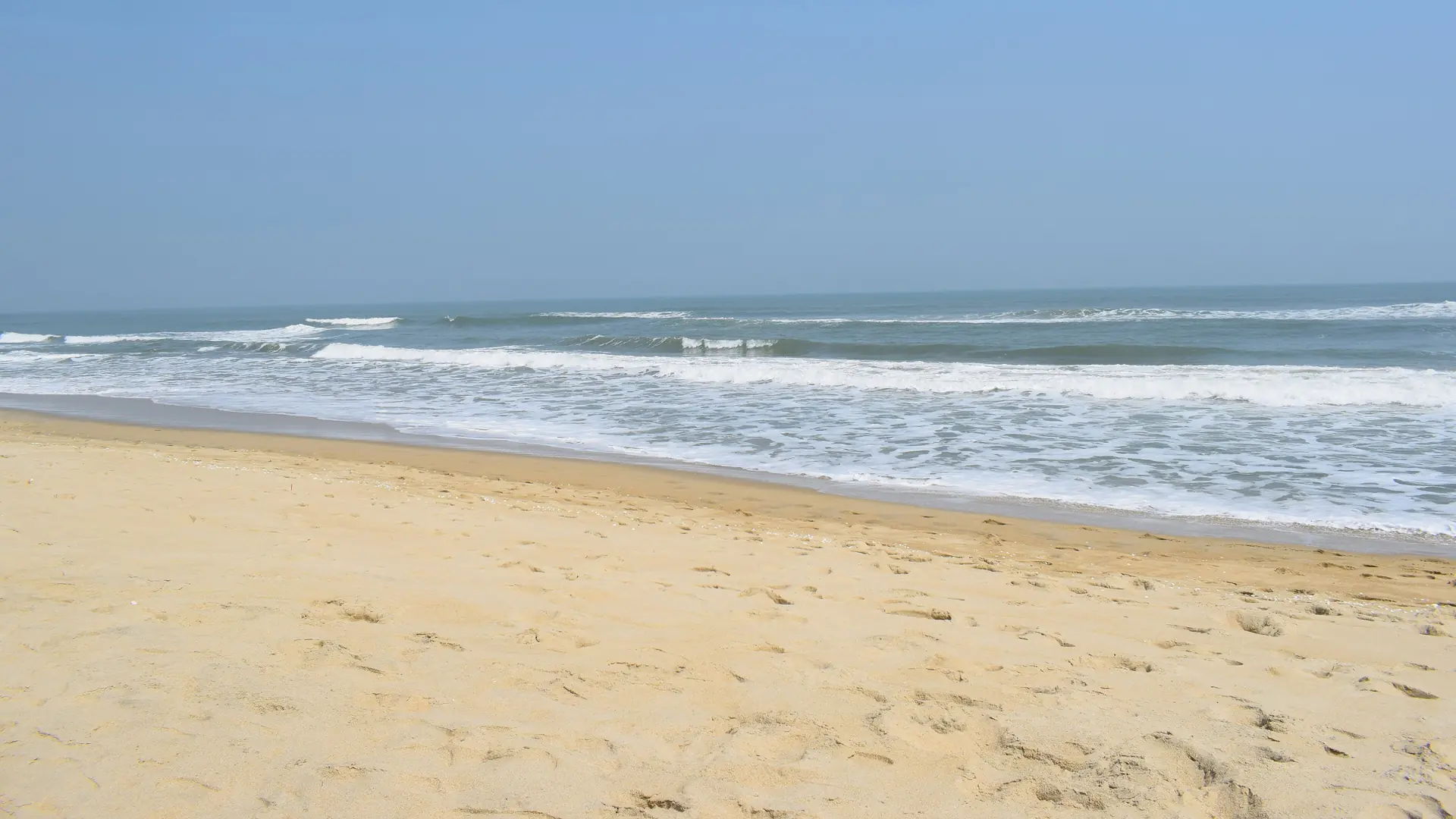 Waves reaching the golden sand of An Bang Beach near Hoi An