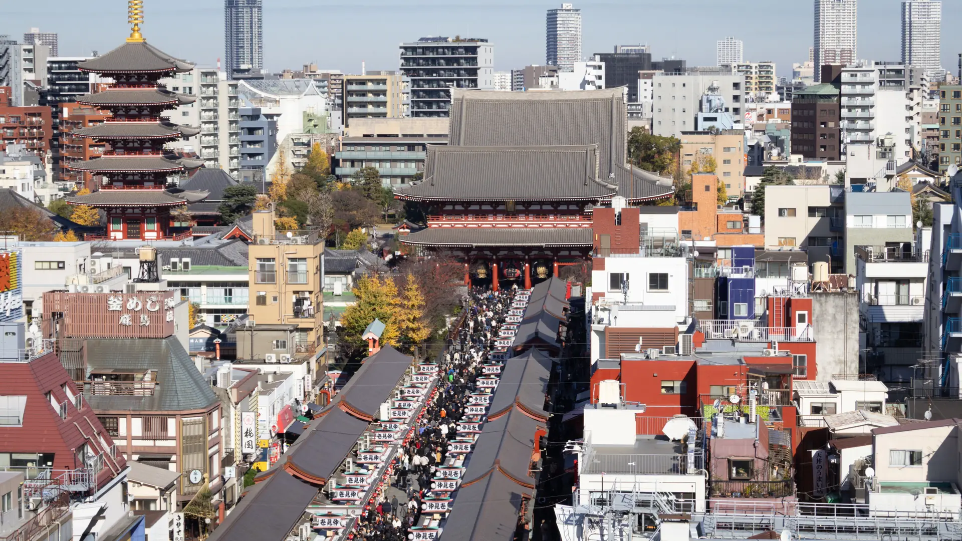 Senso-ji Temple, its five-storey pagoda and Nakamise rooftops across sunlit Asakusa
