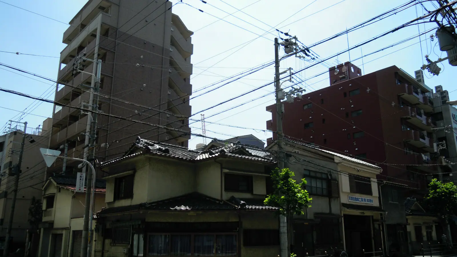 sunny retro lane in Osaka's Nakazakicho district with colourful small shops and cafés
