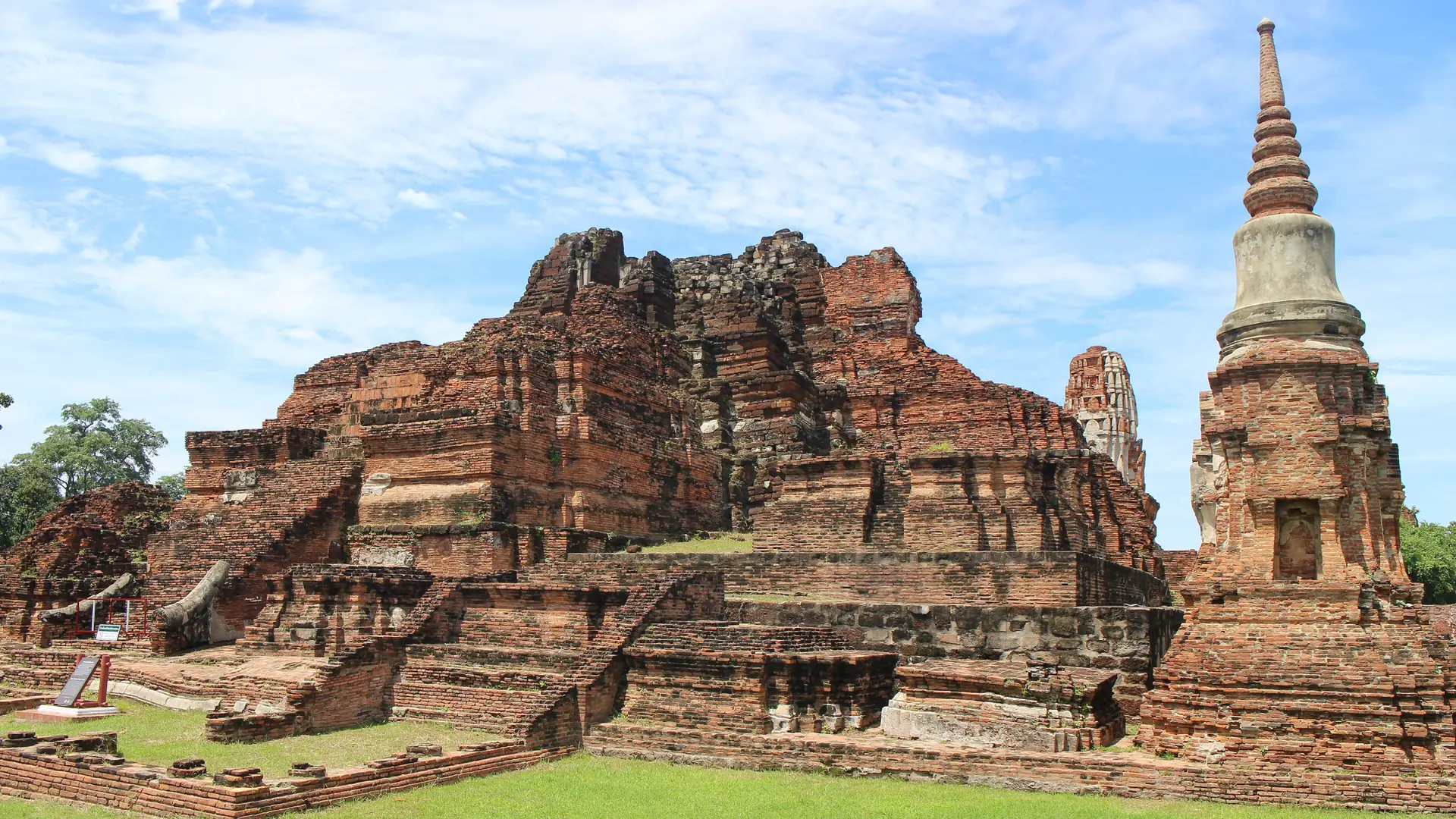 Sunlit brick ruins and a chedi at Wat Mahathat on the historic island of Ayutthaya