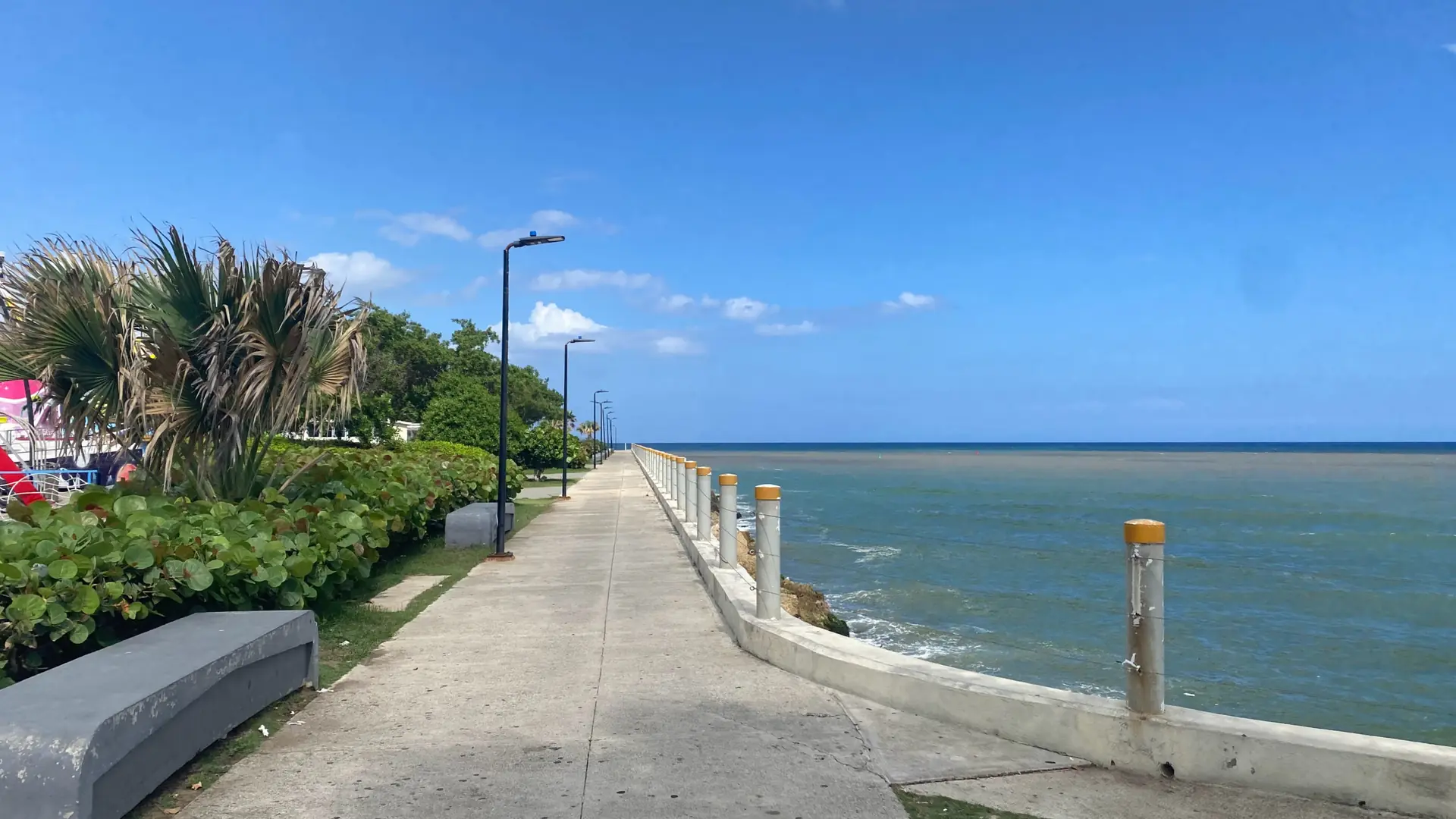 Sunny coastal walkway and Caribbean Sea at Santo Domingo Malecón