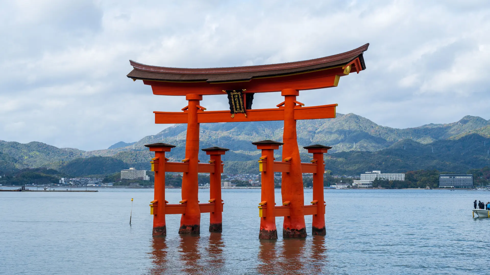 Itsukushima torii standing in the Seto Inland Sea at warm evening light