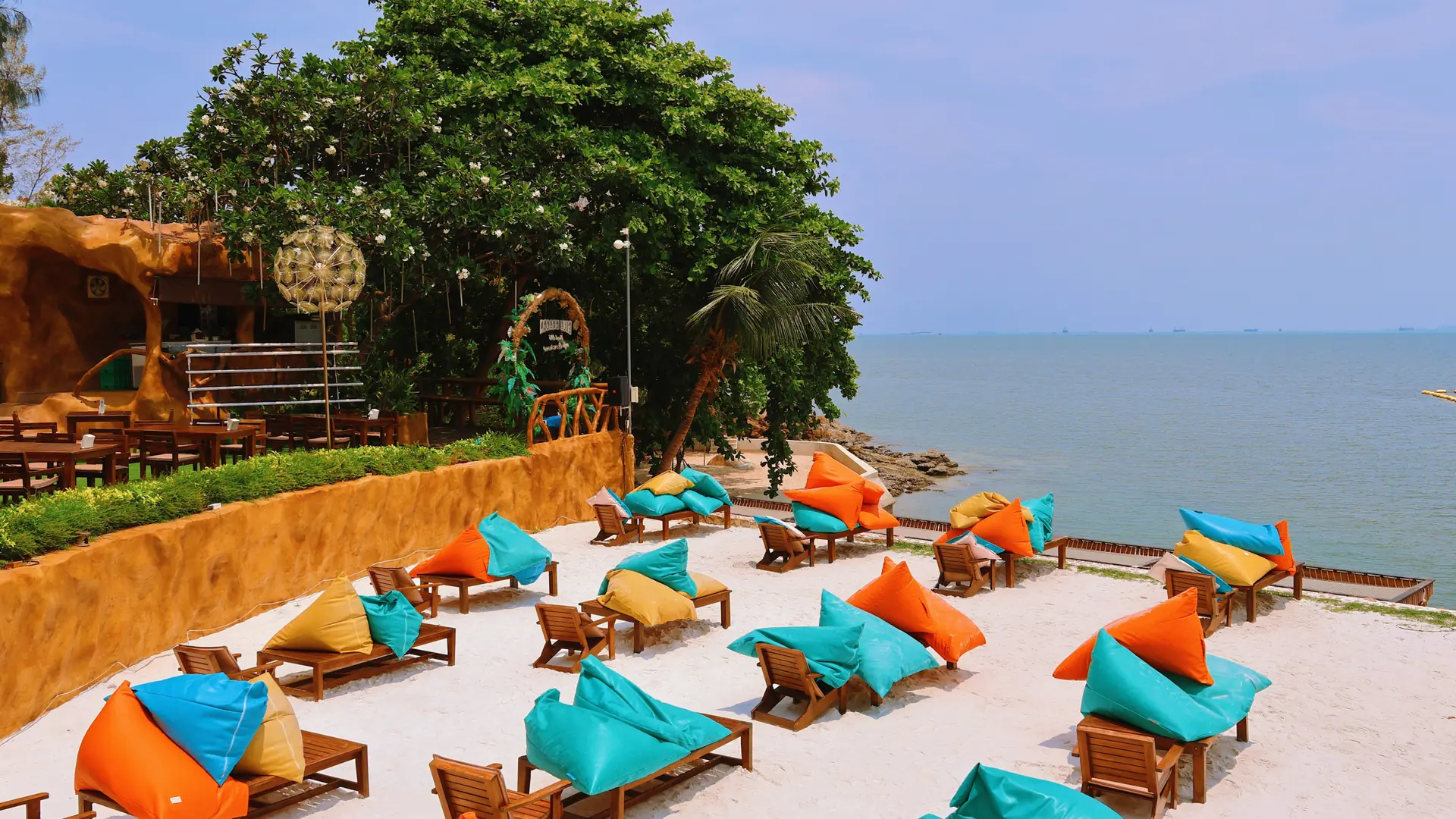 Rows of colourful loungers on the sand at Jomtien Beach