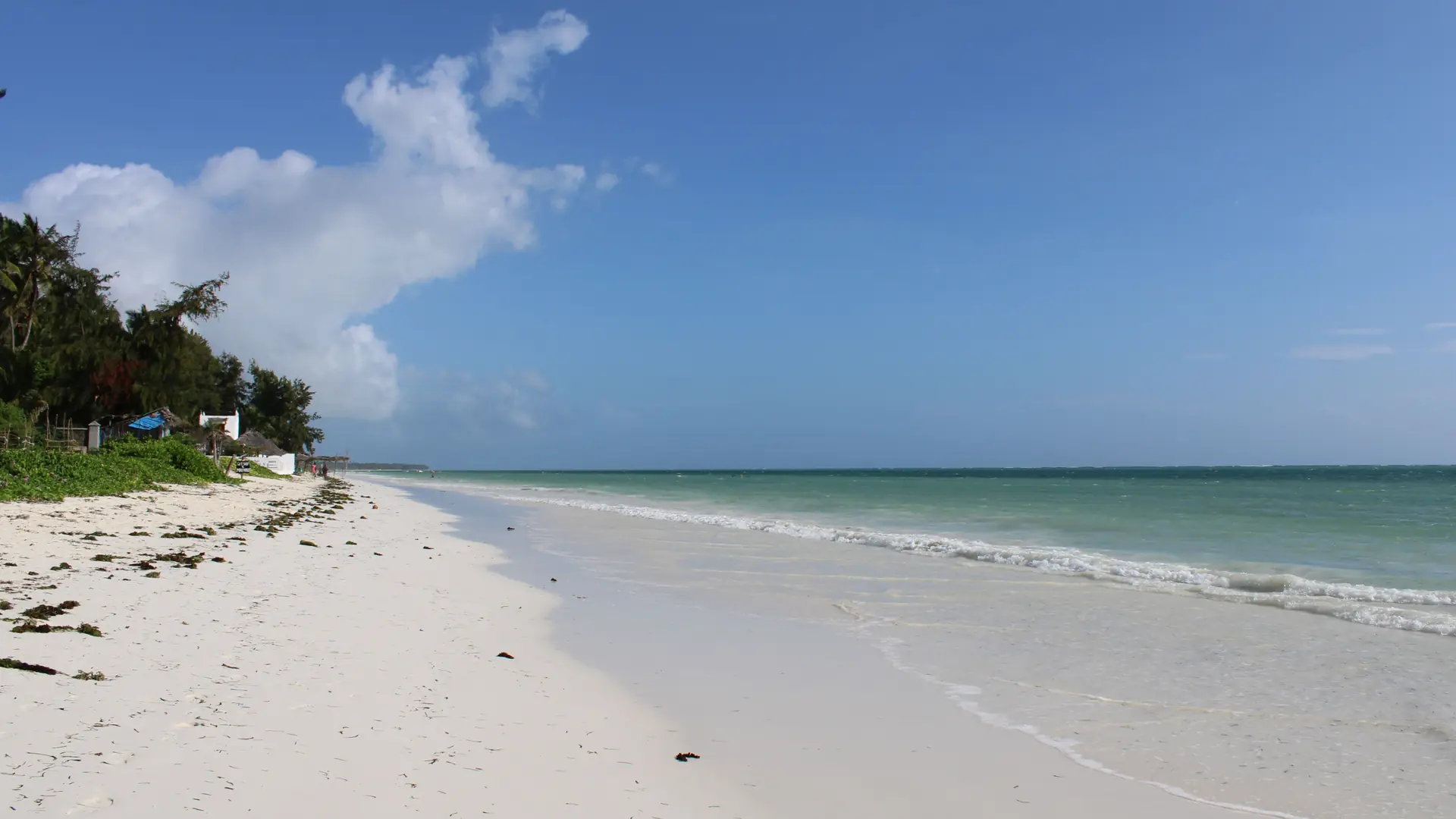 Bright turquoise water and white sand on Zanzibar Island in daylight