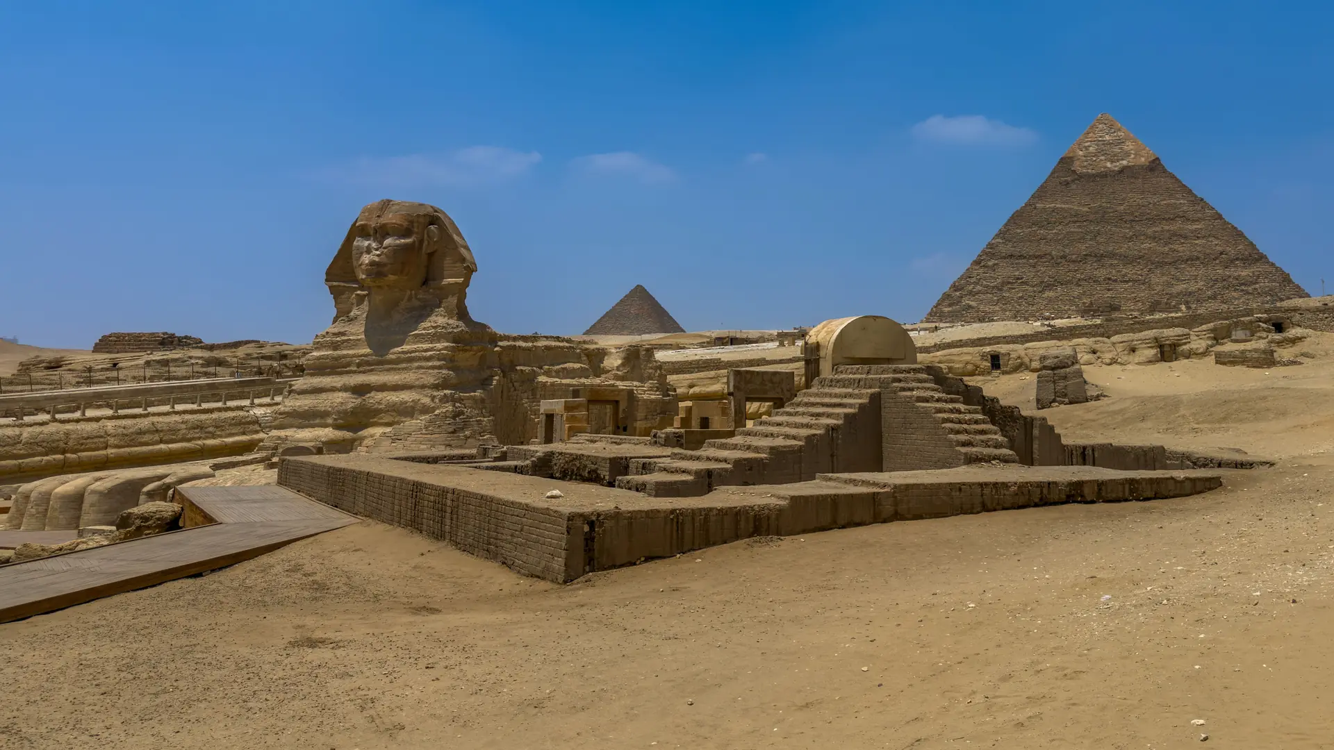 Great Sphinx and pyramid beneath clear blue sky on the Giza Plateau