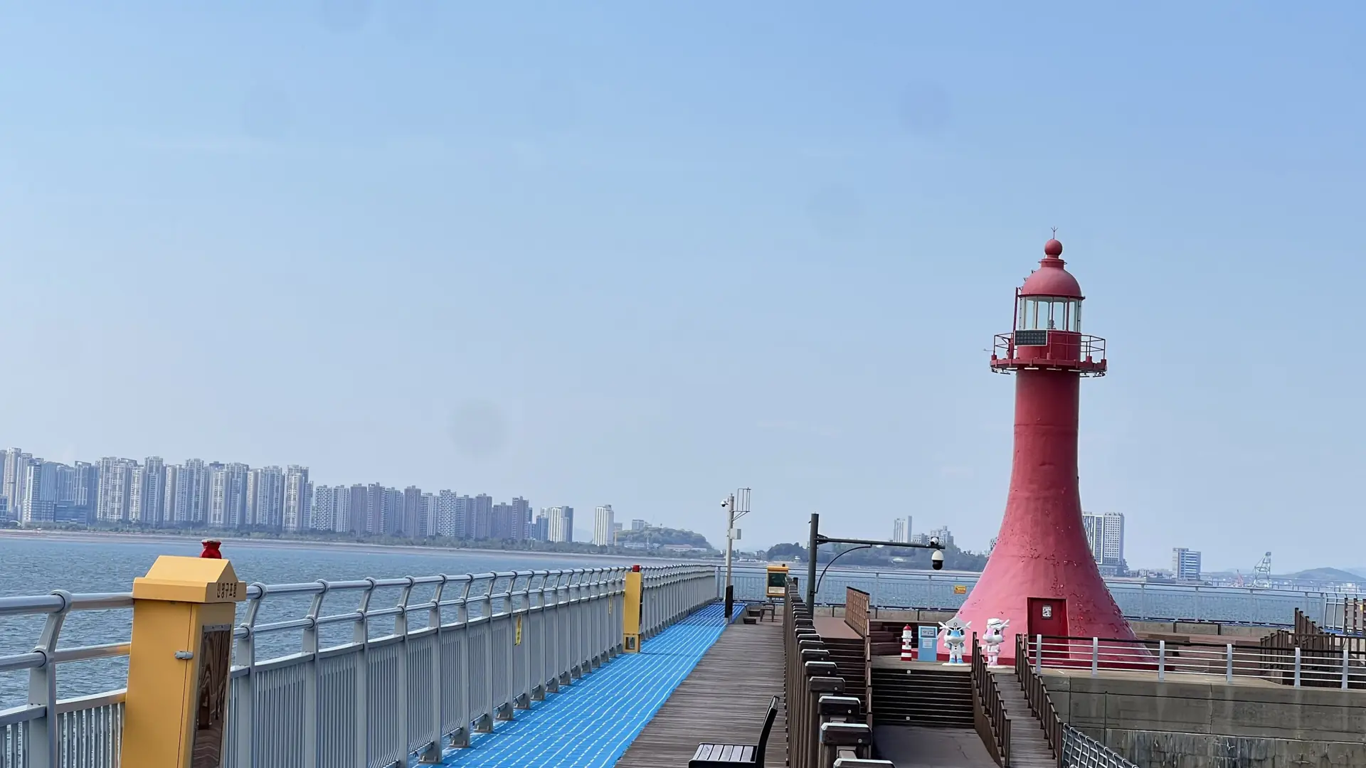 A red lighthouse and boardwalk at Yeonan Pier, a wider Incheon waterfront view rather than Wolmido