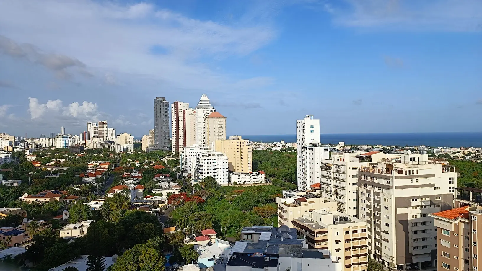 Bright Santo Domingo skyline with modern towers and sea in the distance