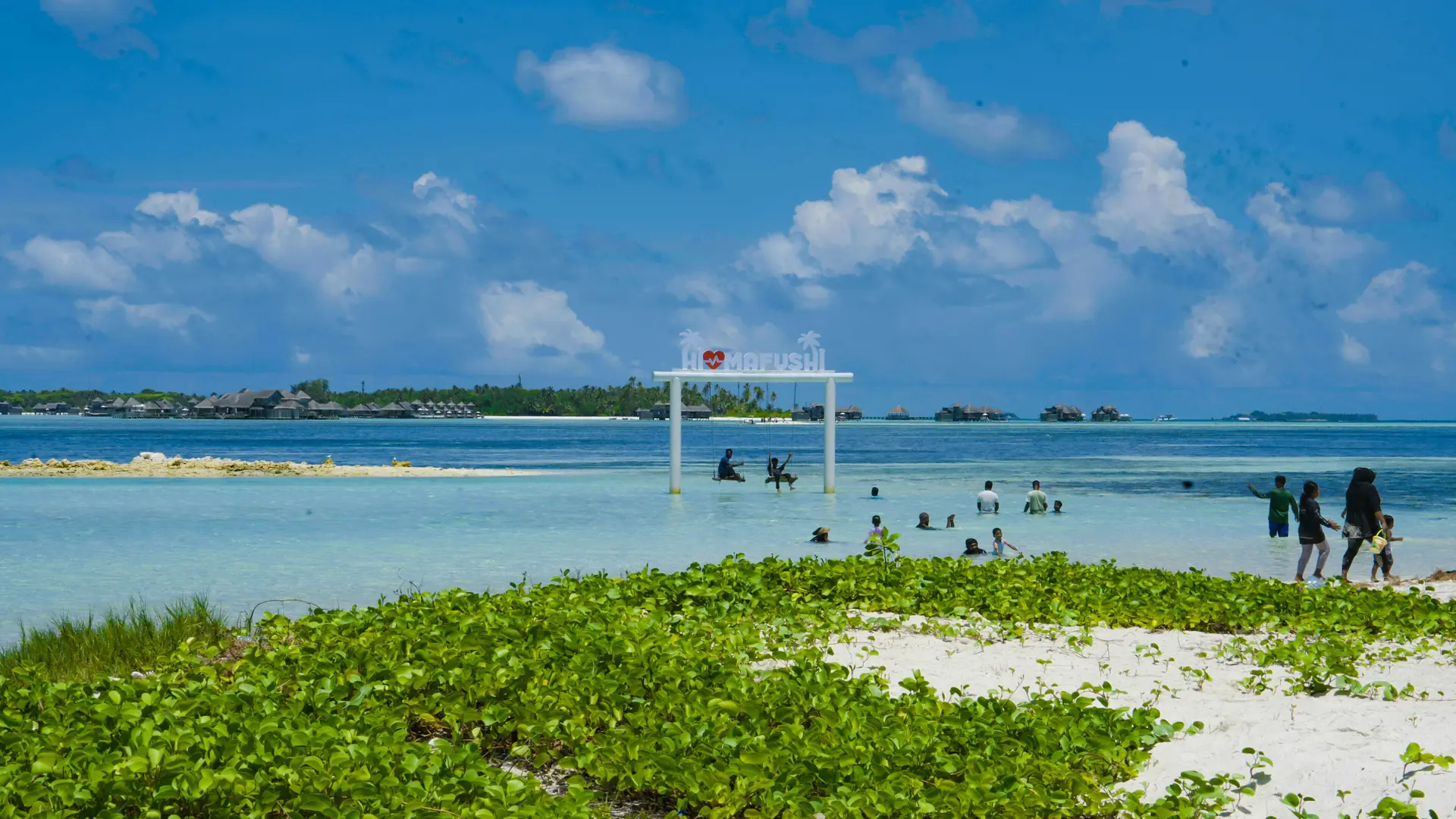 People enjoying the local beach on neighbouring Himmafushi island
