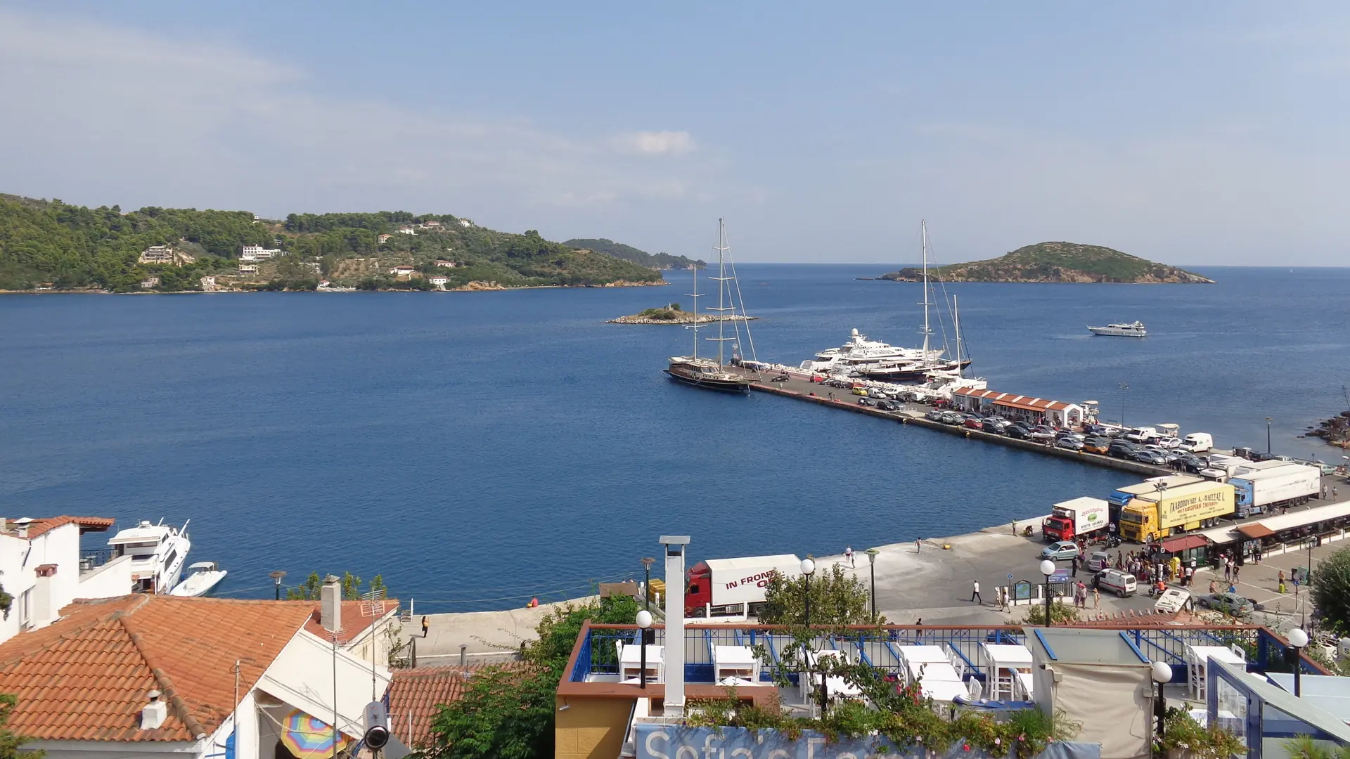 Boats and quays in Skiathos Town’s new harbour, with green Pounta beyond