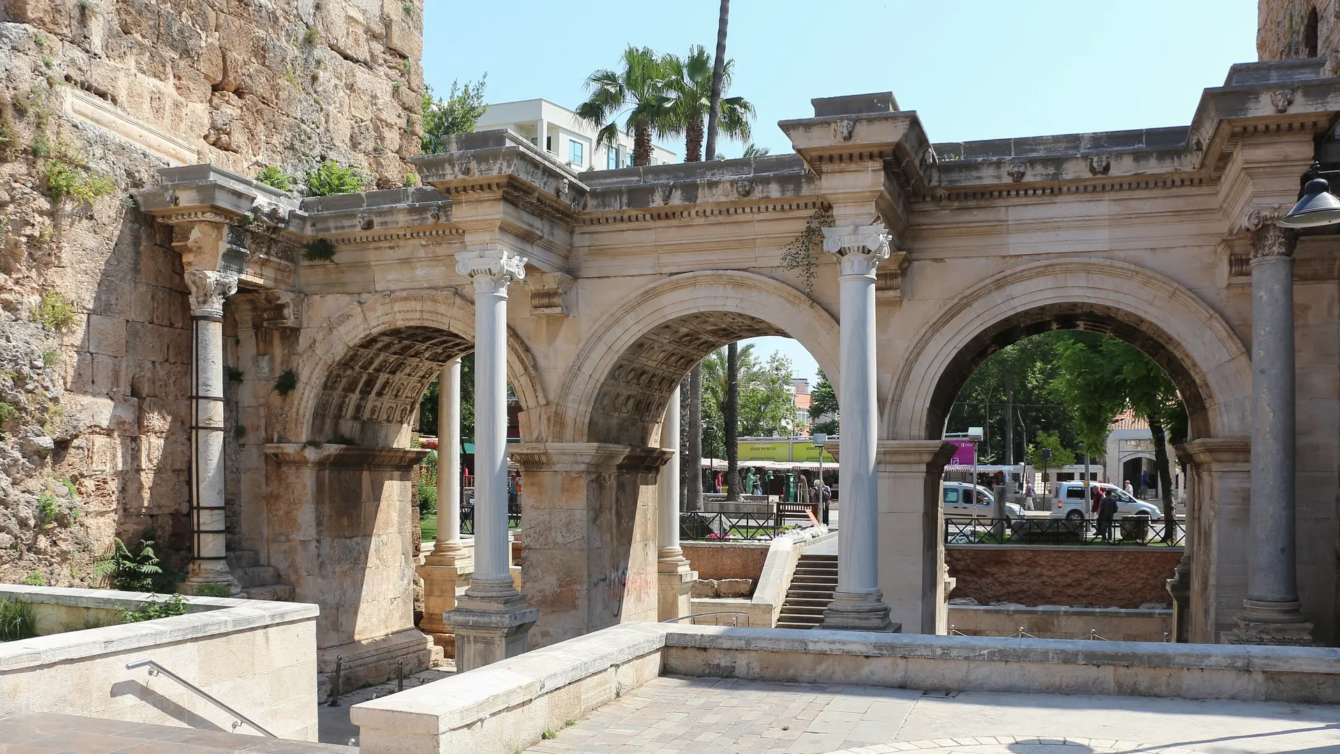 The three marble arches of Hadrian’s Gate in Antalya under a bright daytime sky