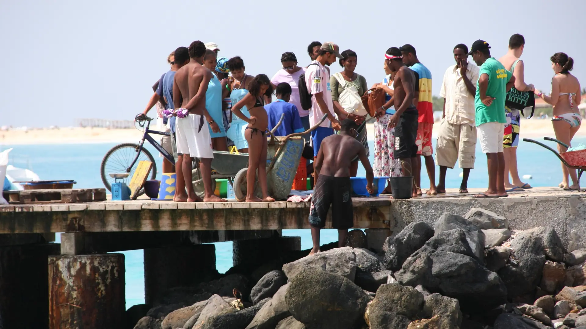 People on the sunny fishing jetty at Santa Maria, Sal