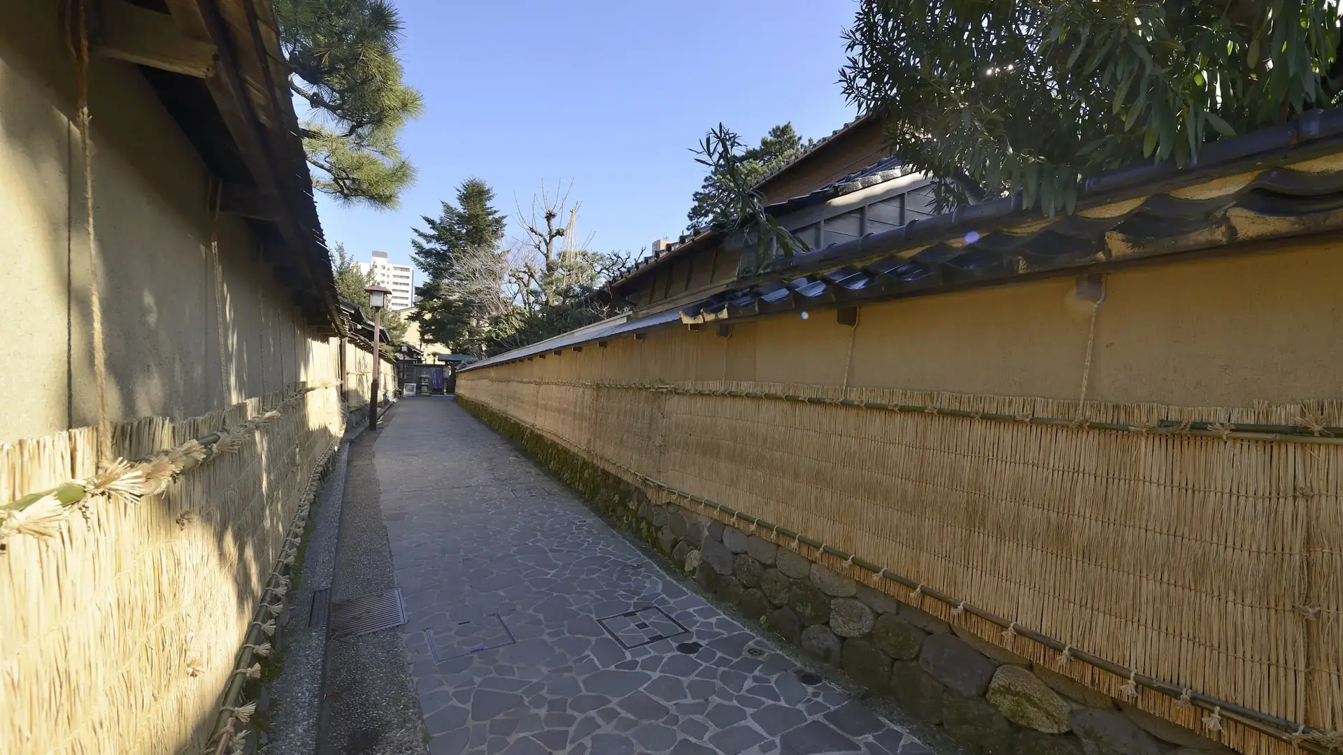 Nagamachi samurai walls and canal glowing in clear afternoon light