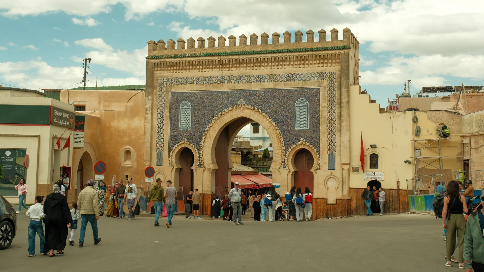 Bab Boujloud's blue tiled gate and visitors at the entrance to Fez medina
