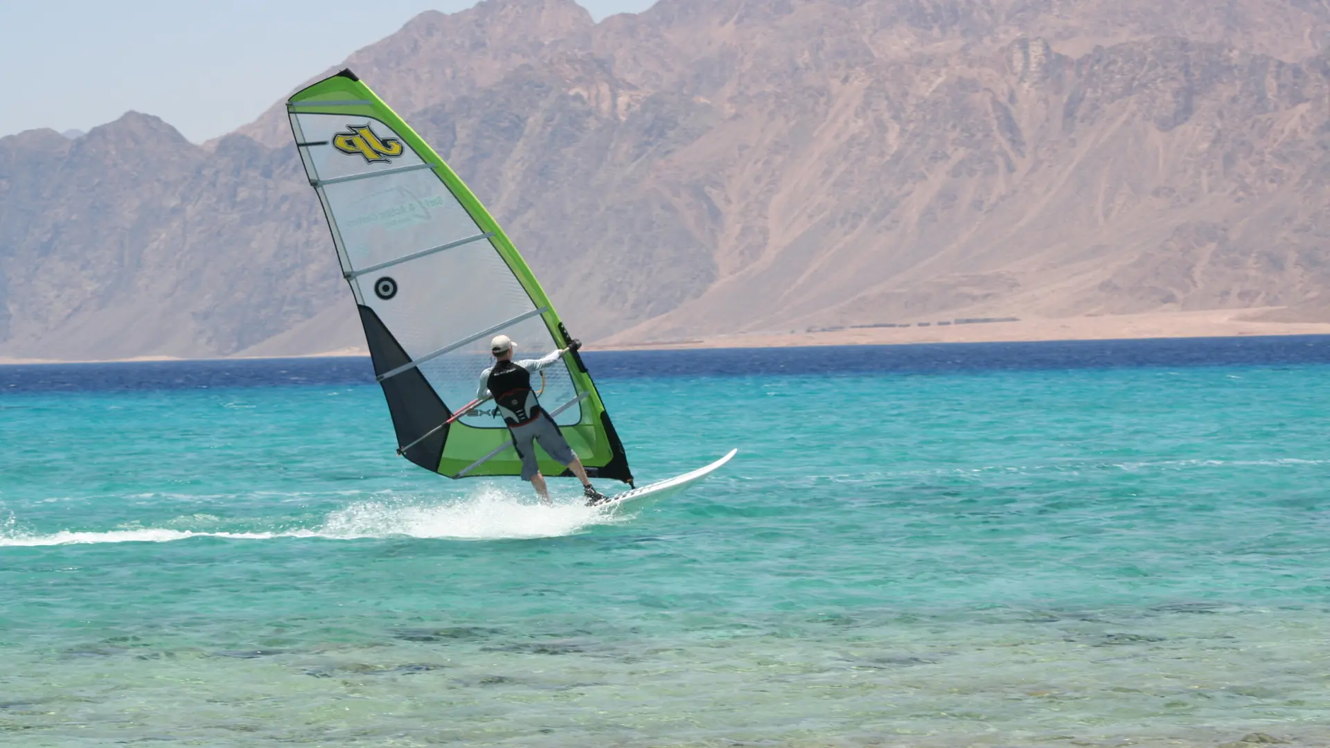 Windsurfer crossing turquoise water at Laguna, Dahab