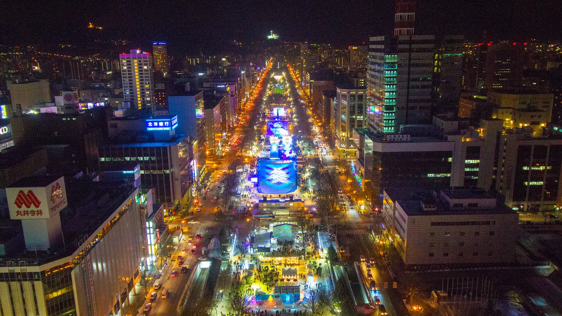 Snow-covered Odori Park and Sapporo skyline at blue hour