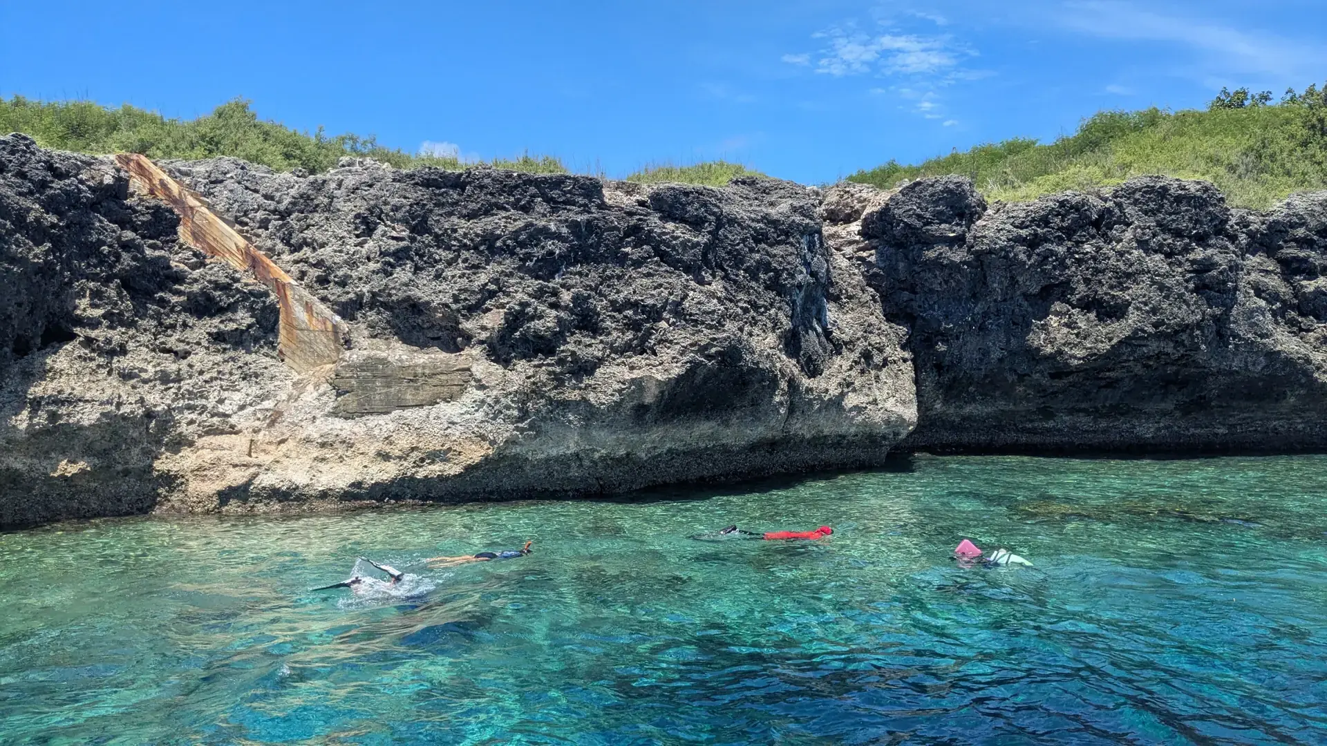 Snorkellers beside the limestone shore of Pescador Island near Moalboal