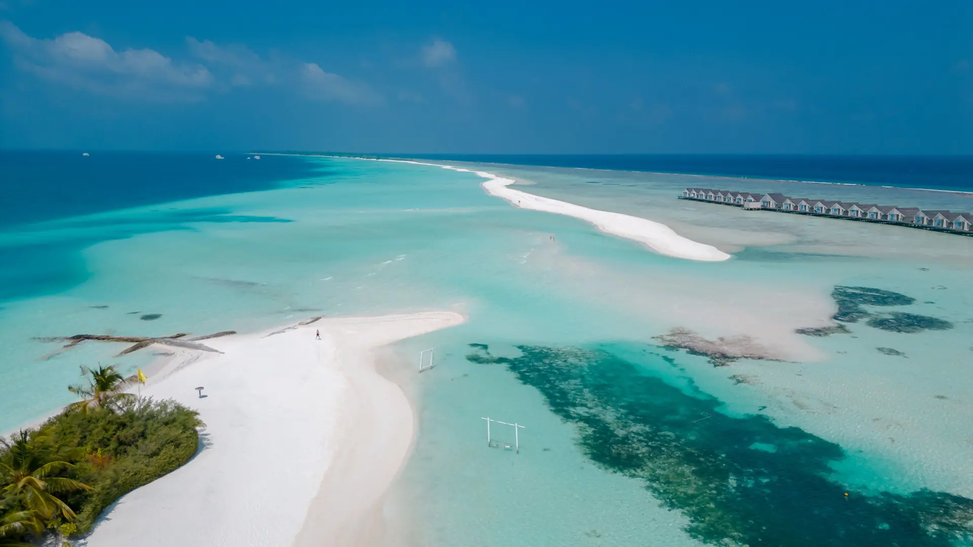 White sand and overwater villas on neighbouring Dhidhoofinolhu in South Ari Atoll