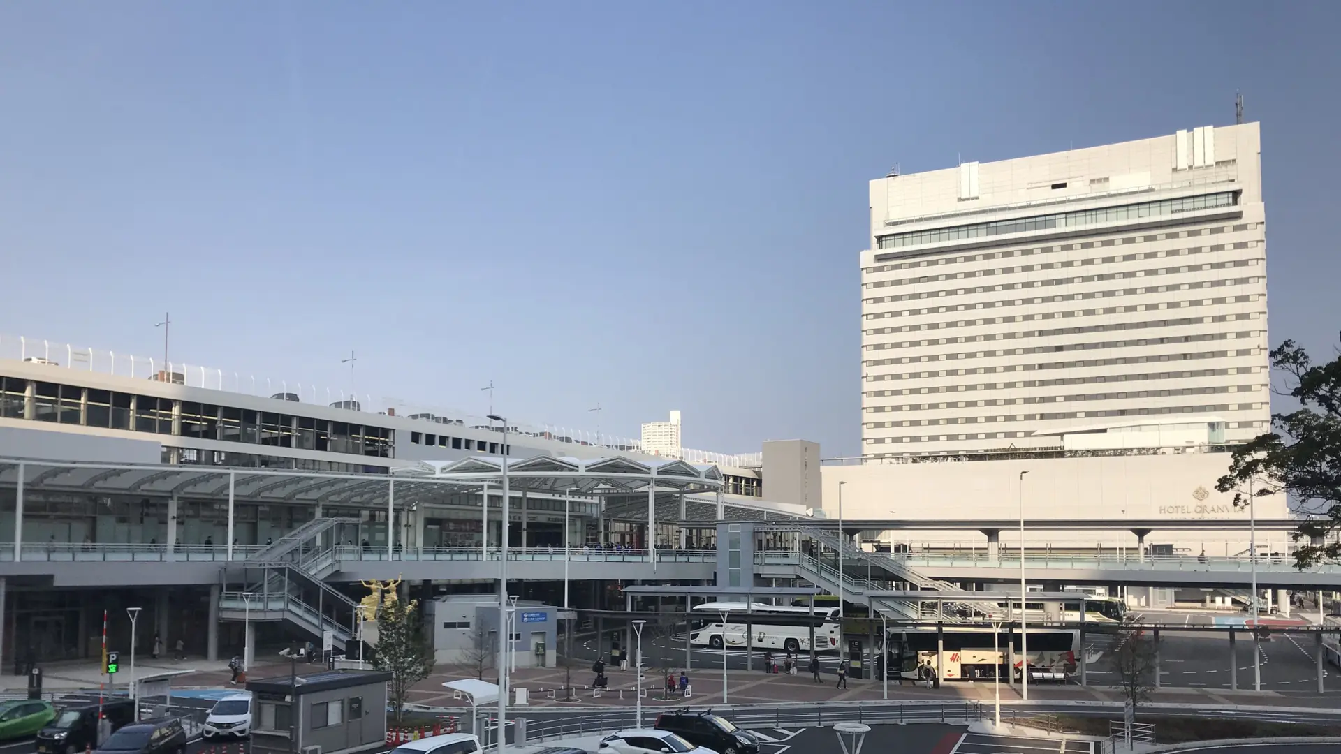 Hiroshima Station’s sunlit north-side plaza and glass walkways beside Hotel Granvia