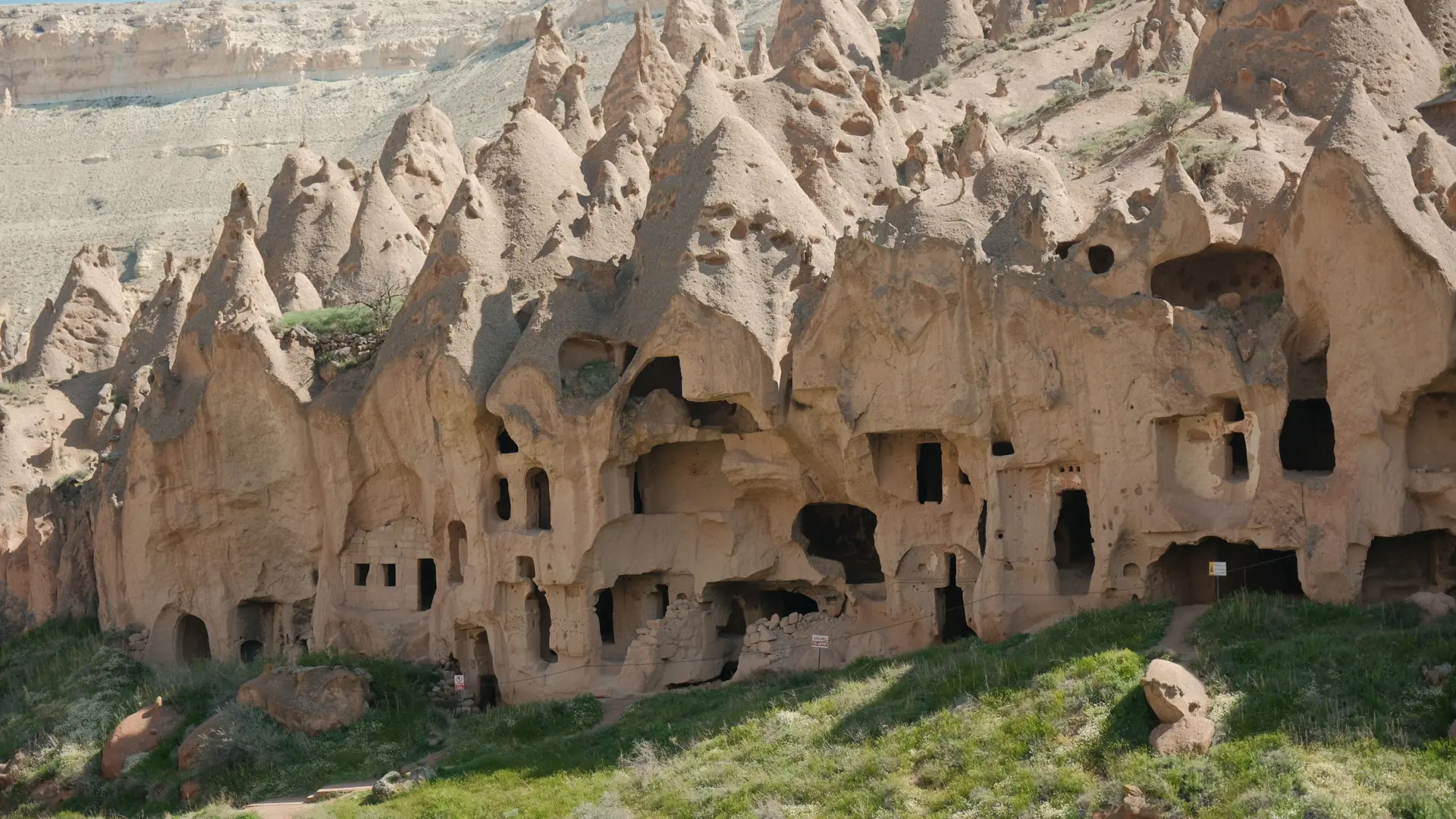 Cave rooms cut into a pale Cappadocia rock face near Göreme