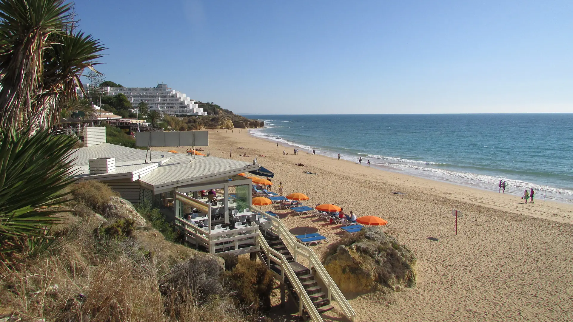 Praia da Oura sand, seafront terraces and white resort buildings in Albufeira