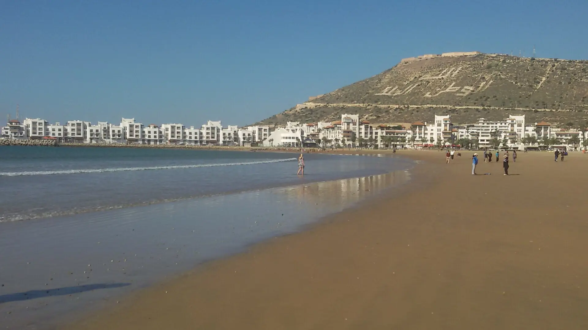 Agadir beach with the Kasbah hill and waterfront buildings in daylight