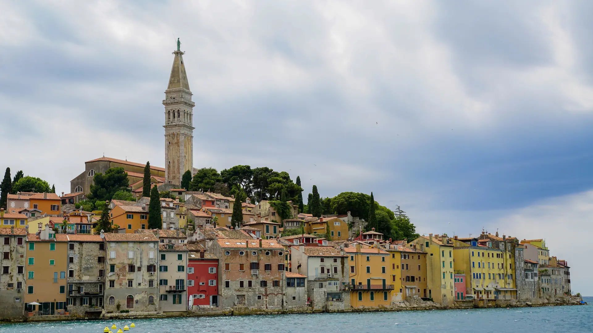 Rovinj old town peninsula, St Euphemia tower and sparkling Adriatic in high summer