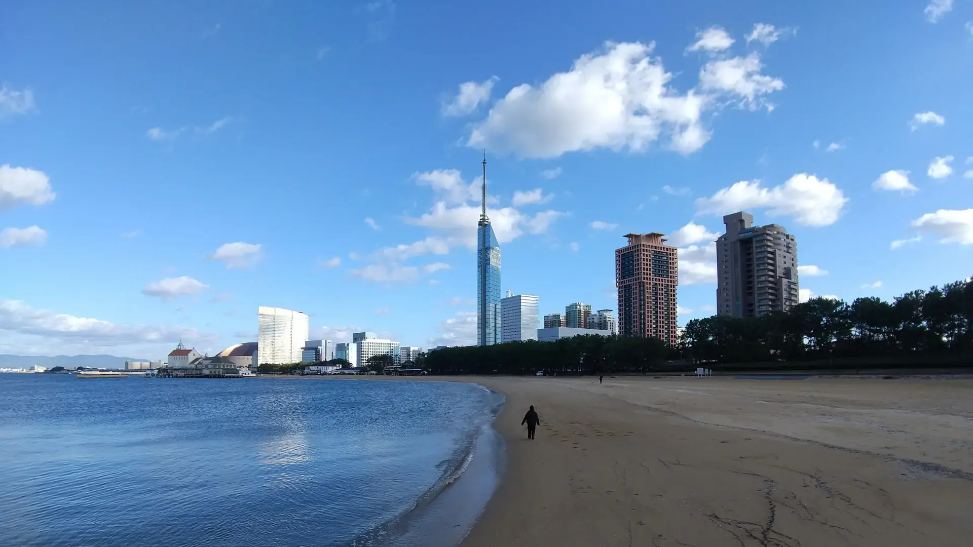 Fukuoka Tower above sunny Momochi beach and deep blue Hakata Bay