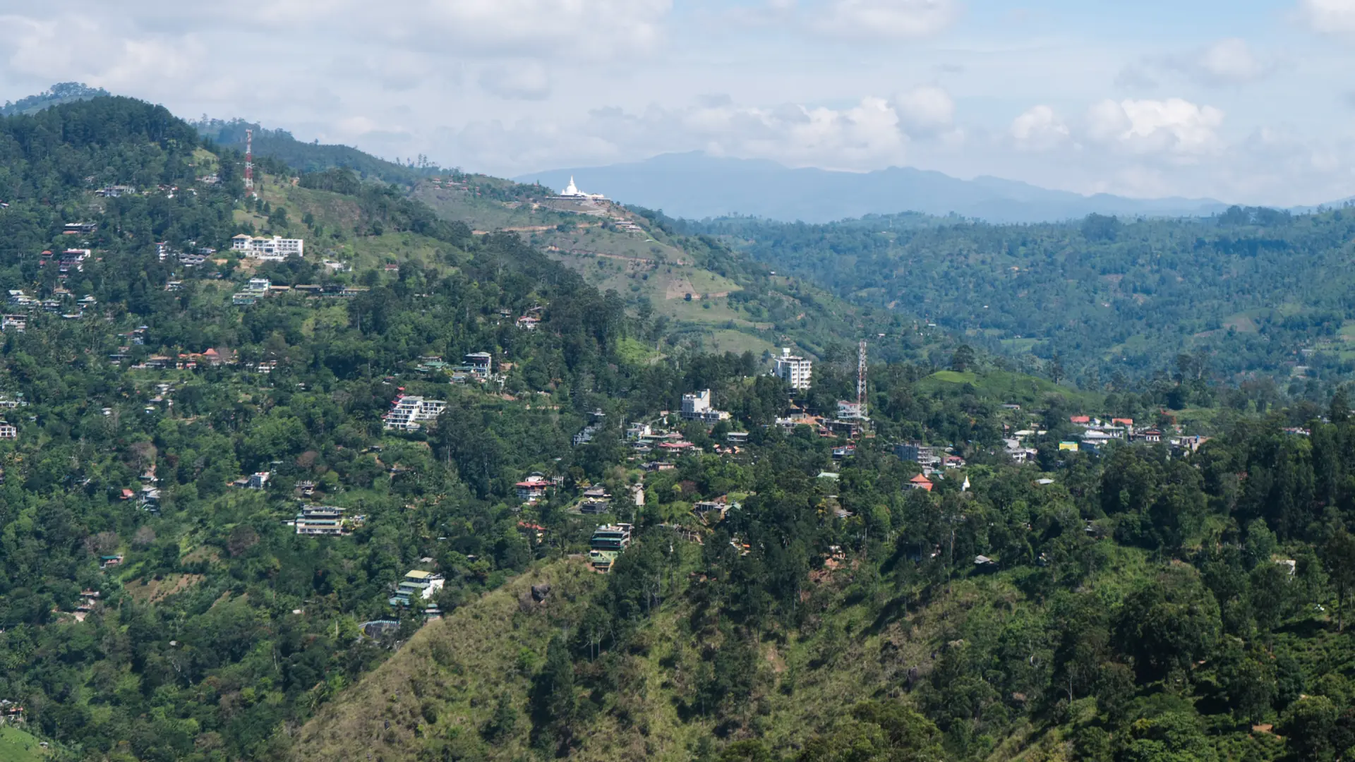 View toward Ella's houses and green hills from Little Adam's Peak