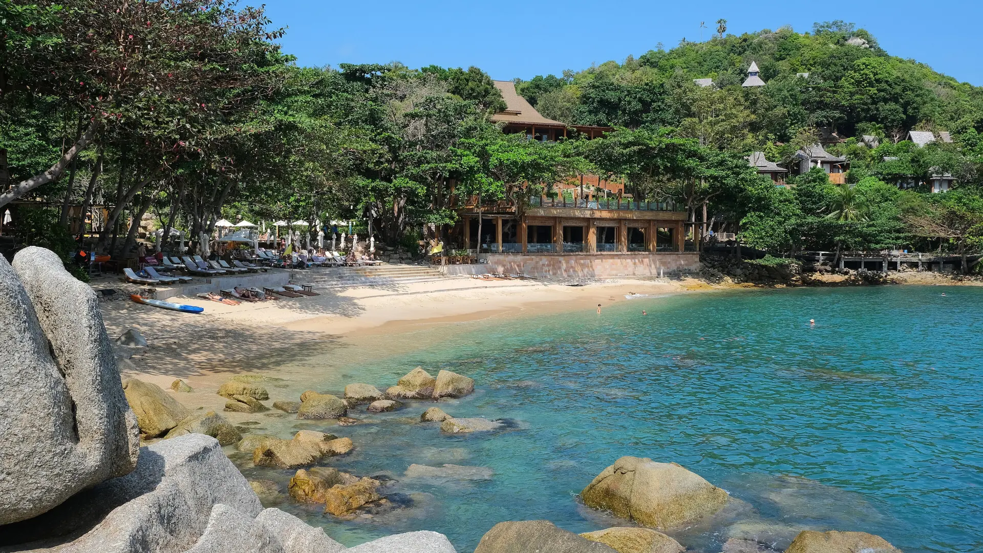 Sunny beach and granite rocks at Santhiya Resort on wider Koh Phangan, rather than Chaloklum