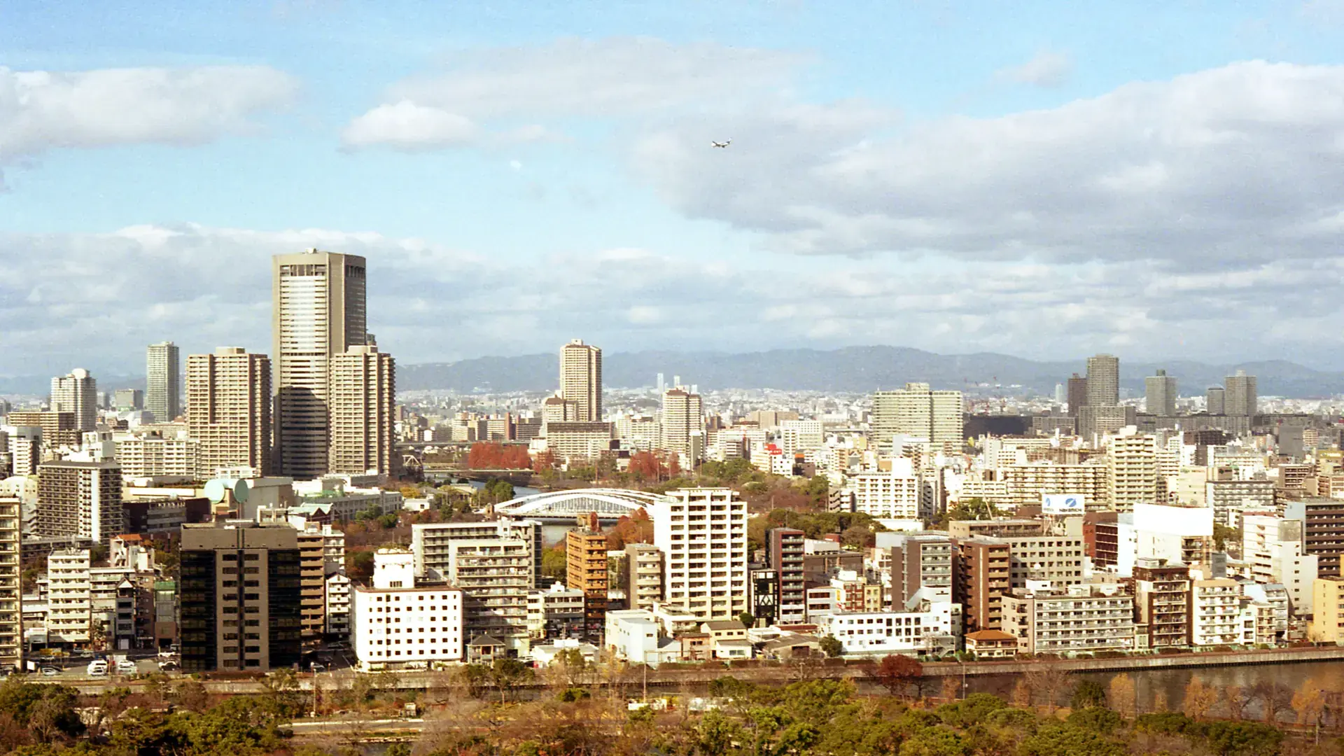 bright wide cityscape across southern Osaka under a clear sky