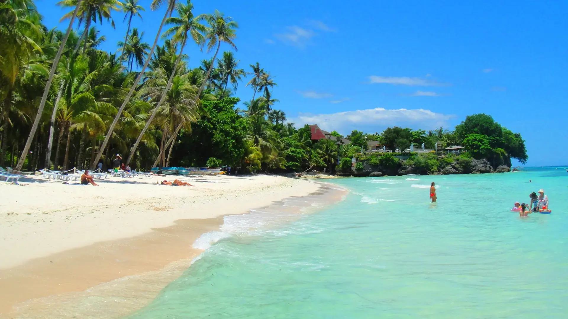 Palm-lined white sand and clear turquoise water at Tawala on Panglao, Bohol