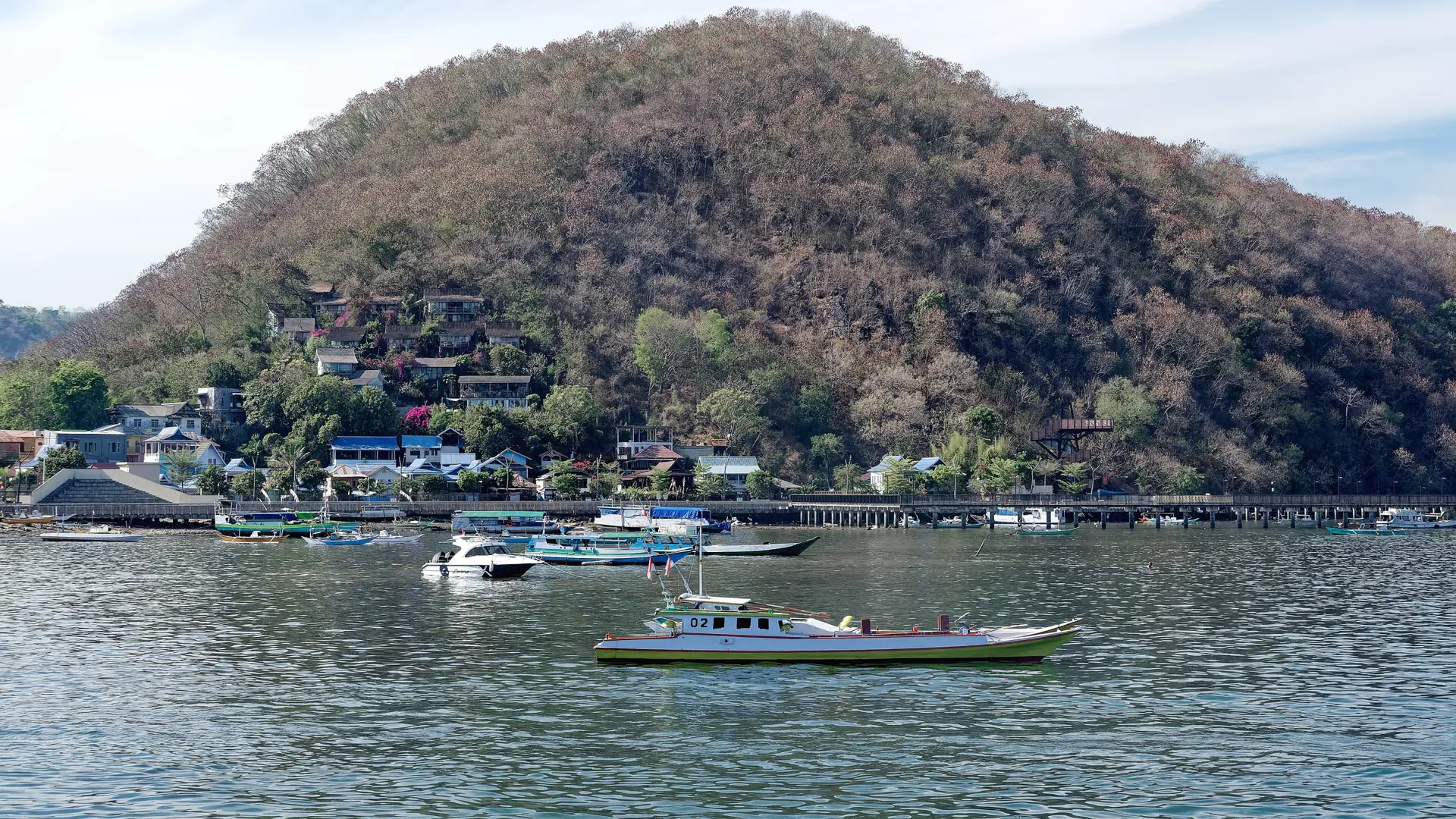 Fishing boats and hillside accommodation along Labuan Bajo’s mainland shoreline