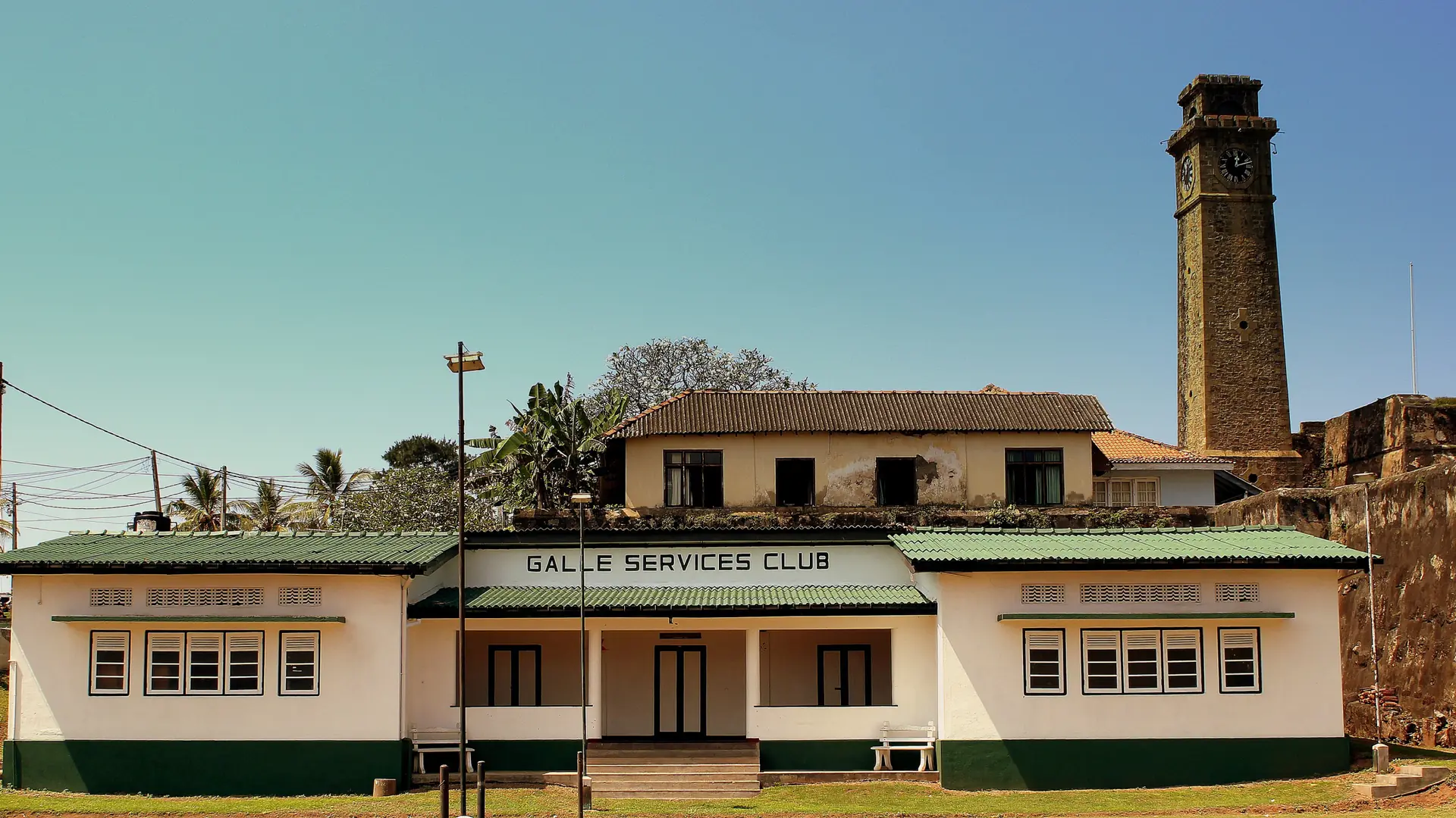 Galle Services Club building beside the fort's Clock Tower in daylight