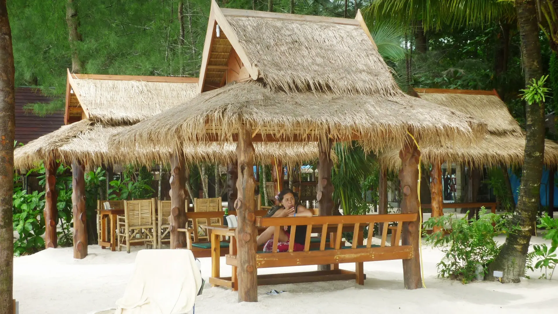 Thatched beach pavilion and pale sand at Khuekkhak in wider Khao Lak, rather than Bang Sak