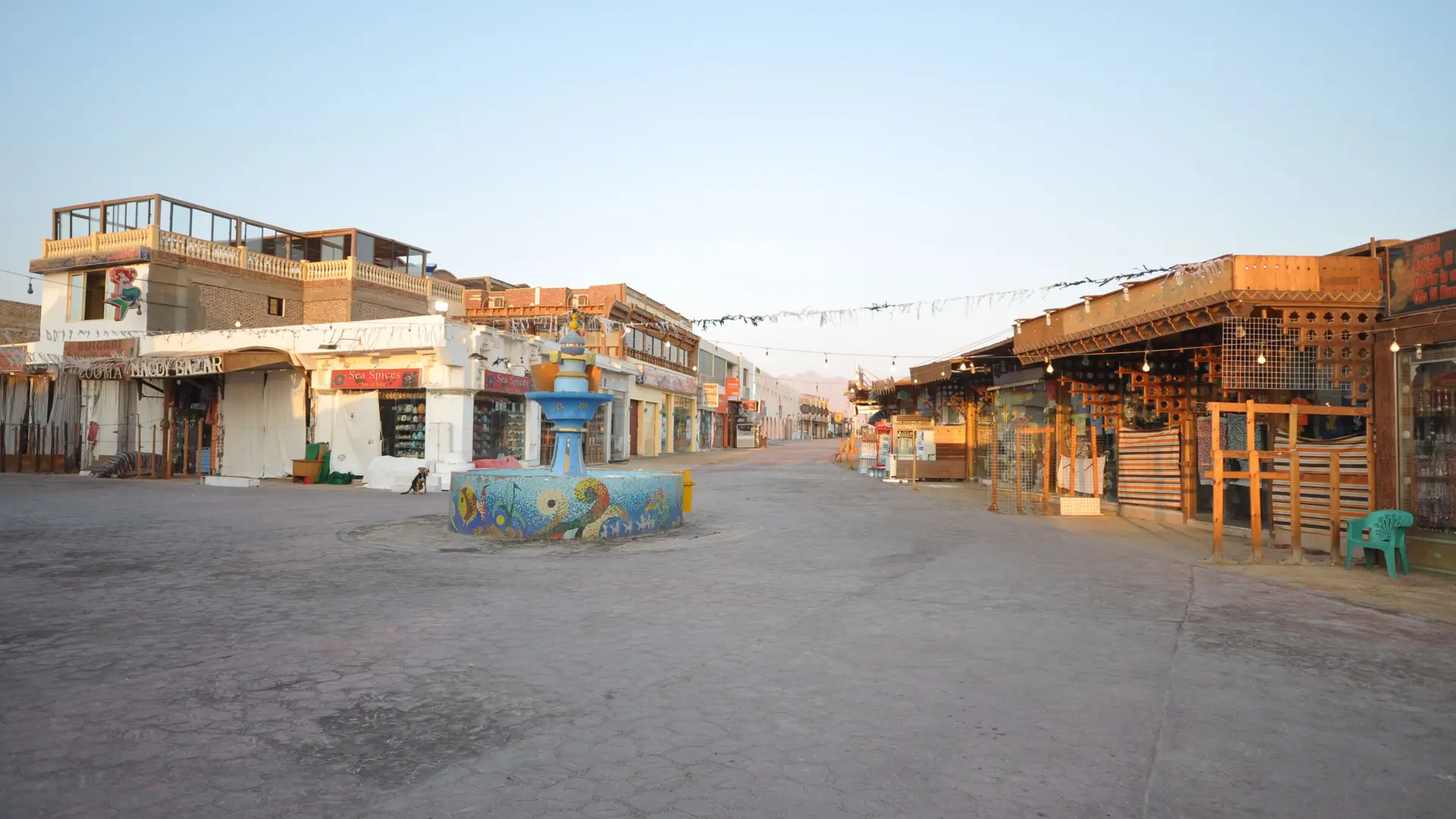 Morning view of Masbat promenade in Dahab, with shops and a small square