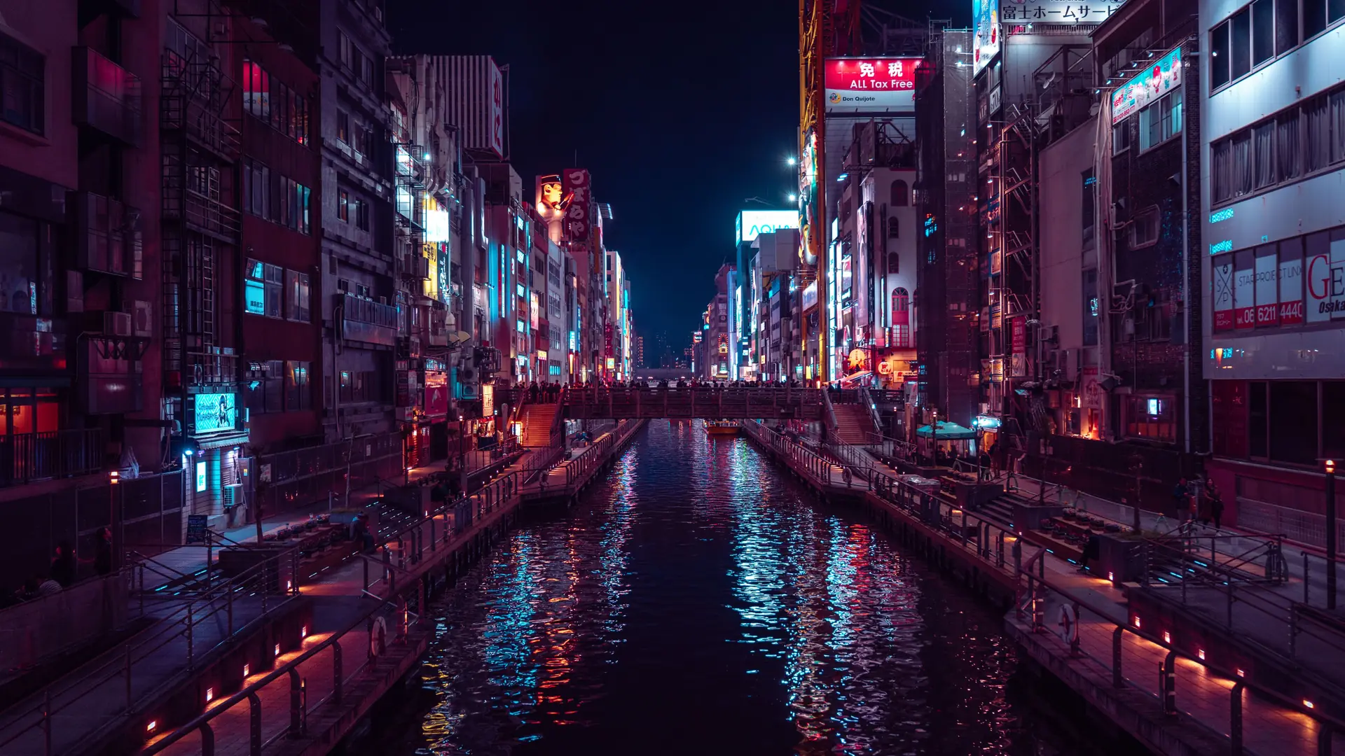 Dotonbori canal glowing with colourful restaurant signs at night