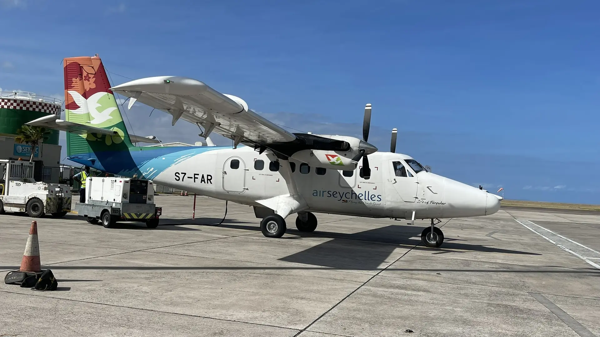 Sunlit arrival apron at Praslin Island Airport near Amitié