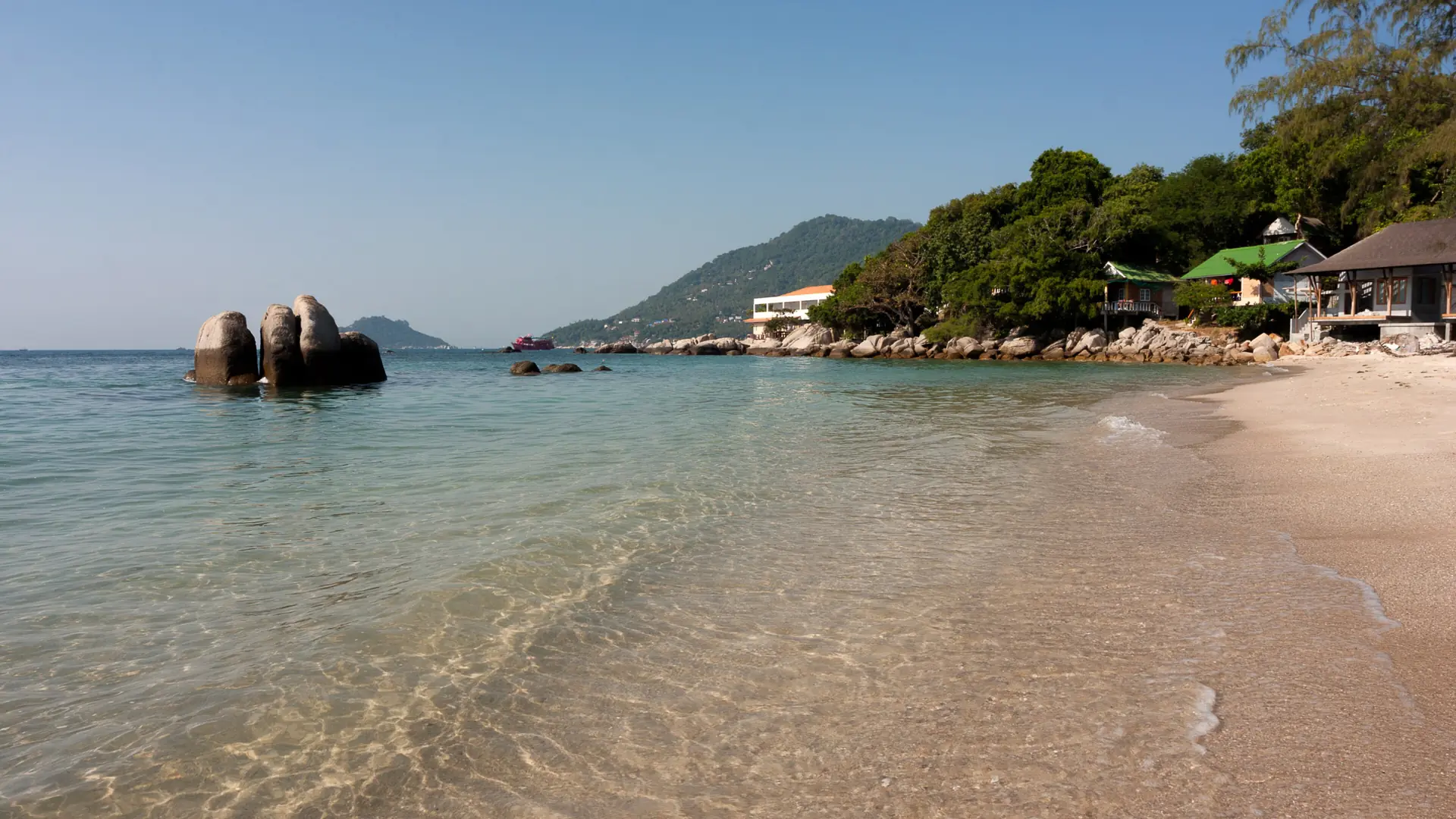 Koh Tao beach boats resting in shallow blue Gulf water