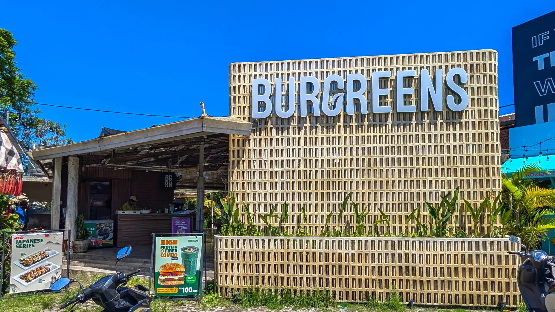 The Burgreens café frontage on a sunny street in Canggu