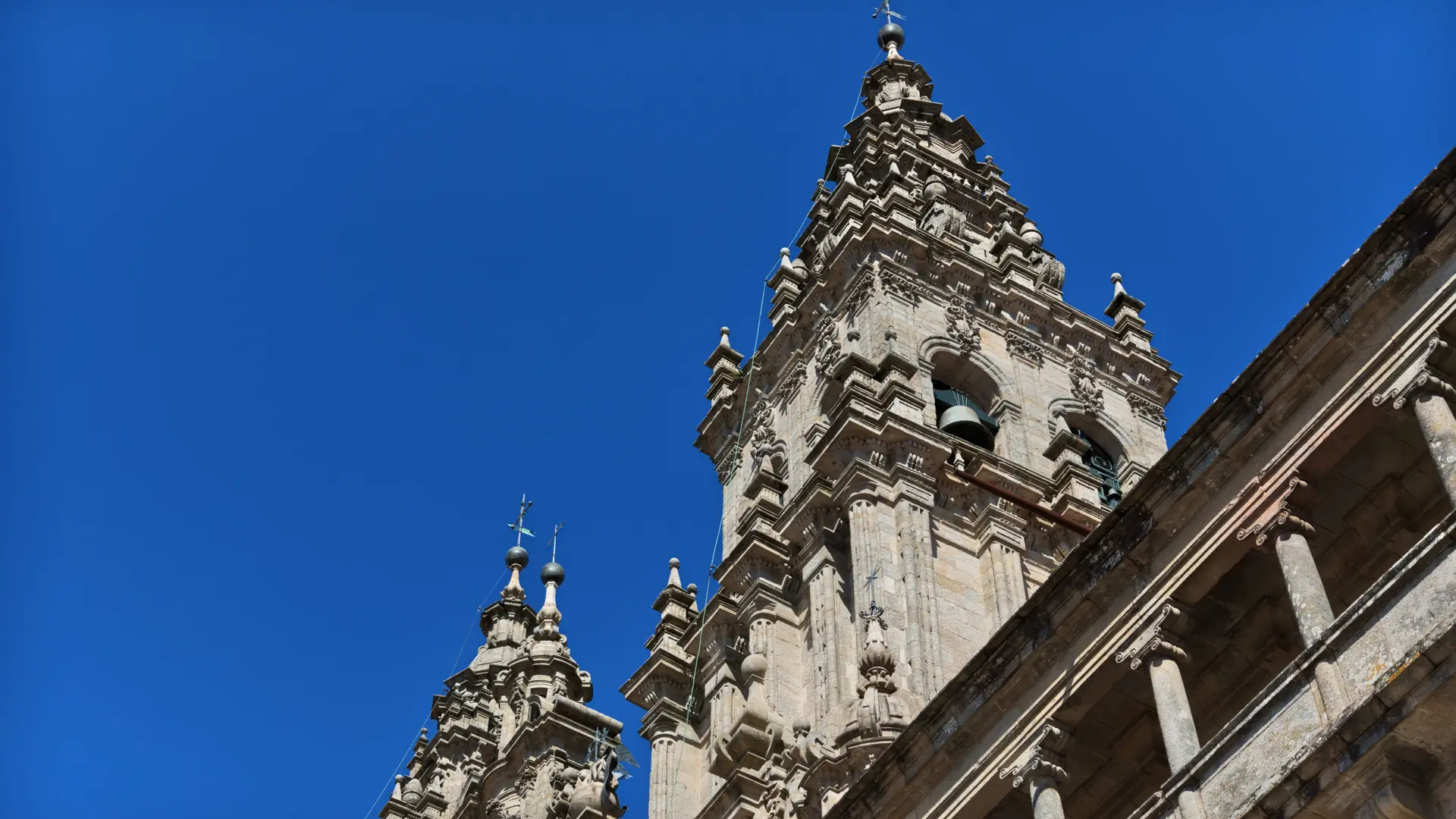The Cathedral’s elaborate western towers beside the cloister against blue sky