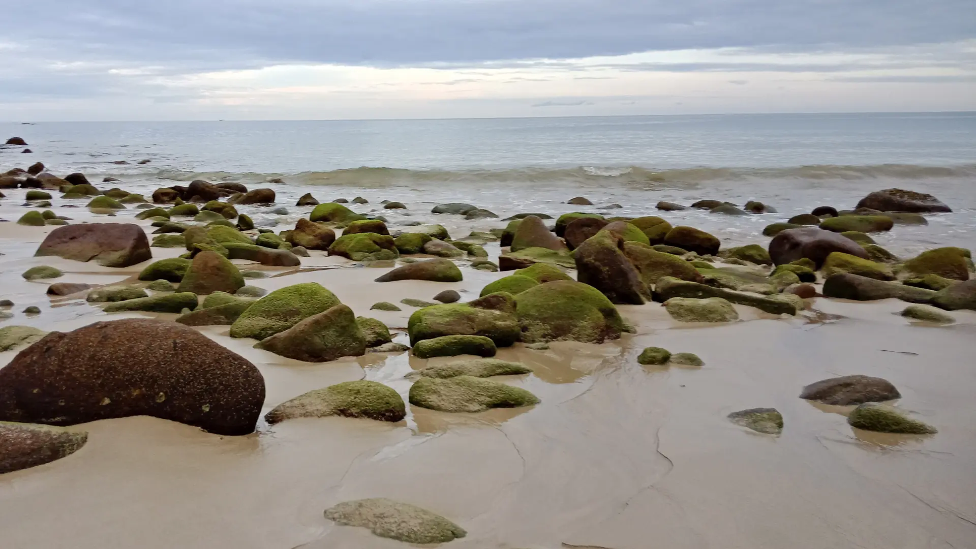 A small sandy Khao Lak cove enclosed by tropical forest