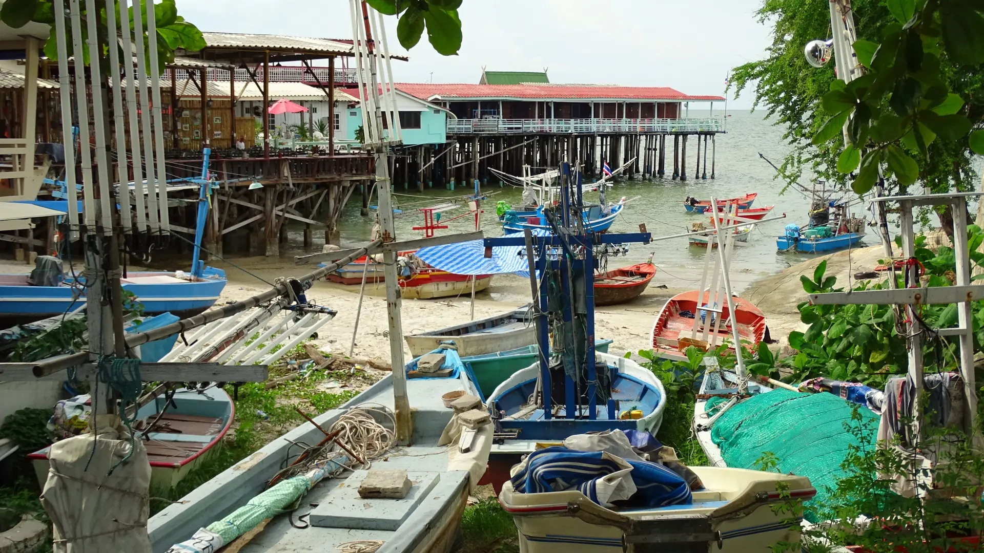 Fishing boats and stilted harbour buildings in Hua Hin, illustrating the wider coastal town
