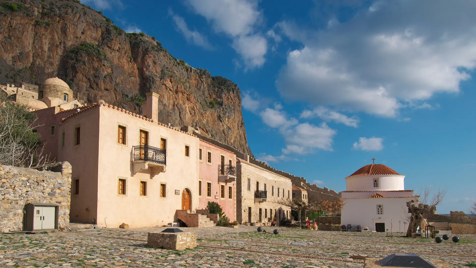 Monemvasia's stone church and fortified rock beneath a vivid blue Peloponnese sky