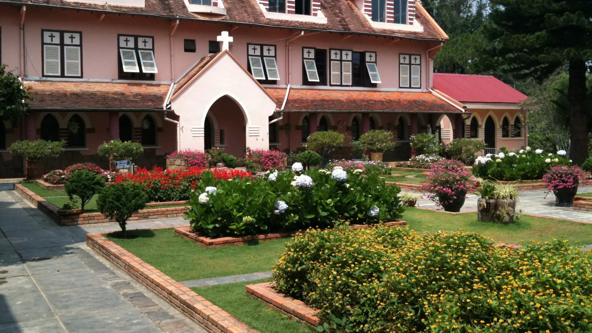 Domaine de Marie’s pink convent and flower-filled courtyard