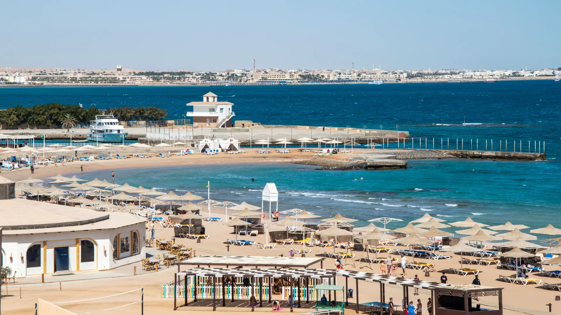 Sunny Hurghada resort beach beside deep blue Red Sea water