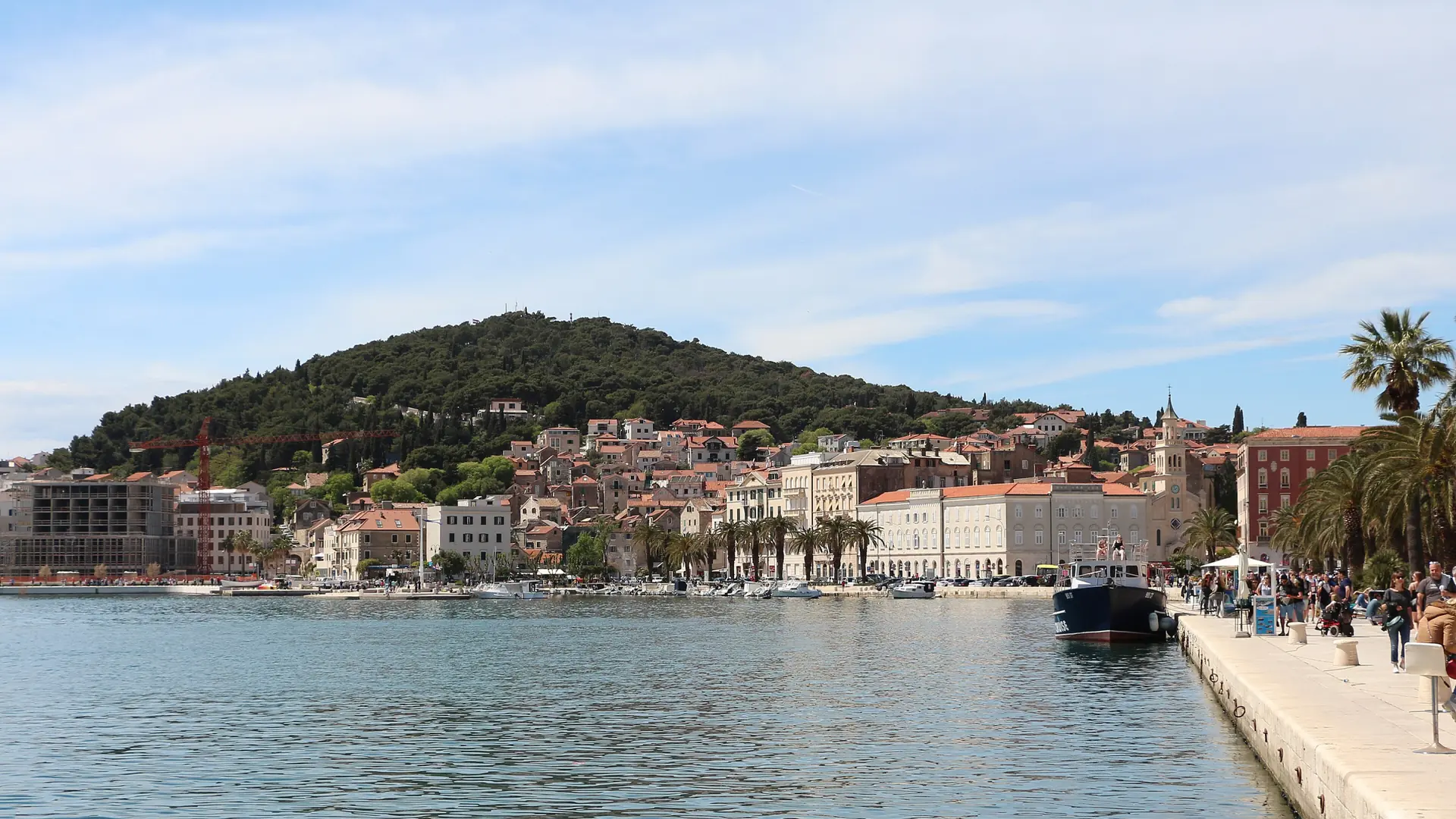 Split's waterfront promenade, cathedral bell tower and Marjan Hill under a bright sky