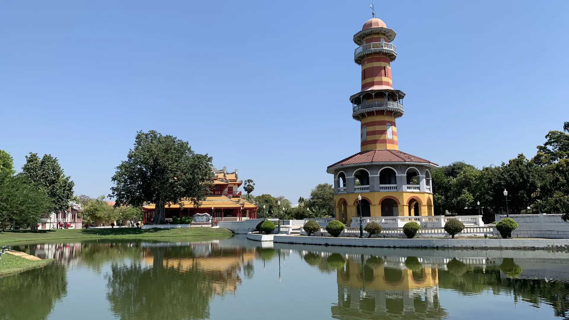 Sunlit Withun Thatsana Tower reflected in the lake at Bang Pa-In Palace
