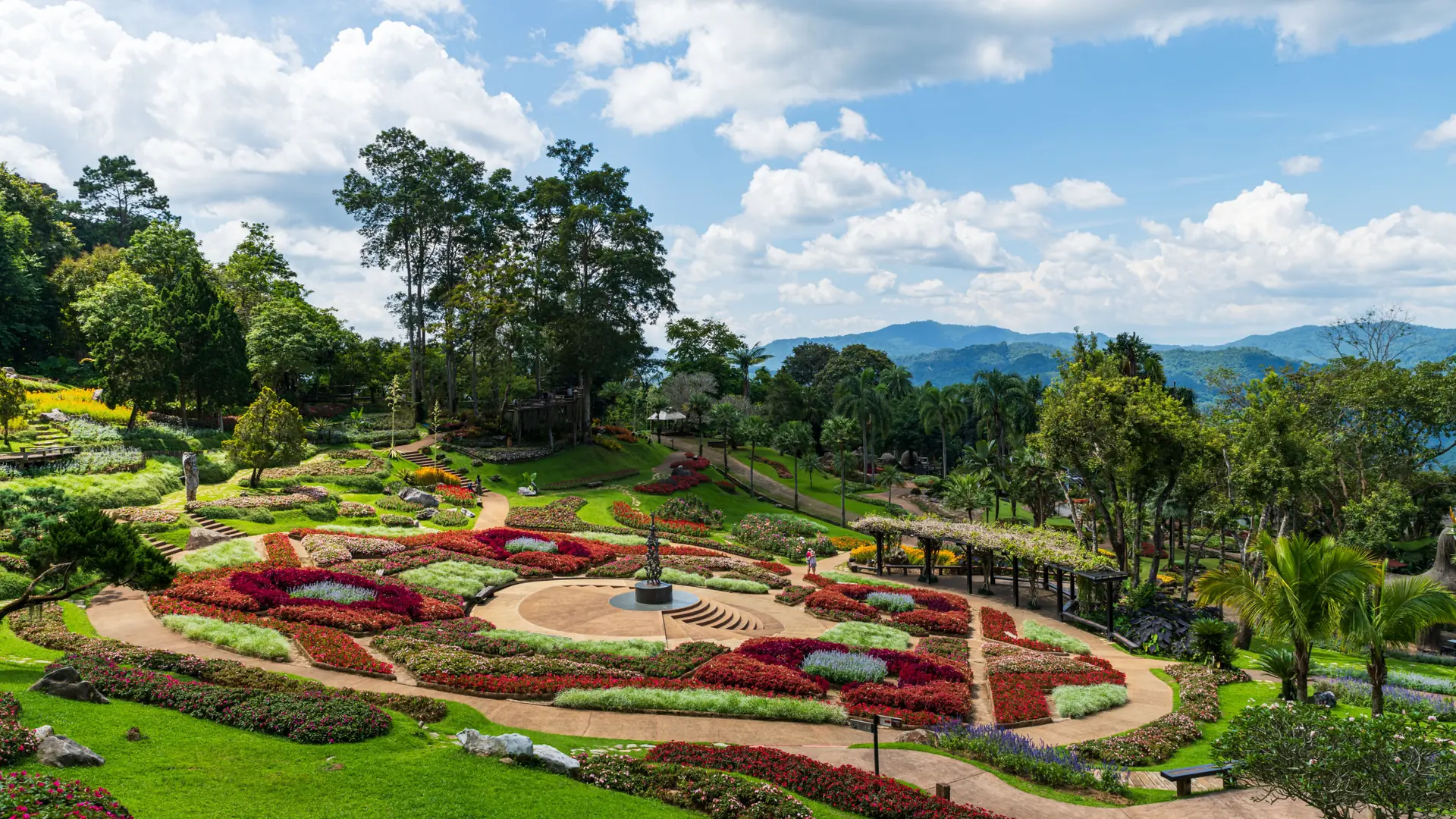Flower beds and wooded hills at Mae Fah Luang Garden on Doi Tung, an optional Chiang Rai outing