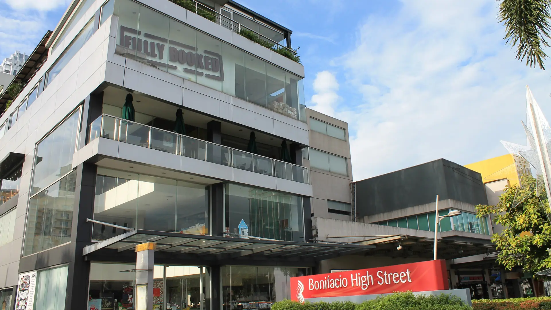 The Fully Booked shop and Bonifacio High Street signs beneath a blue Taguig sky